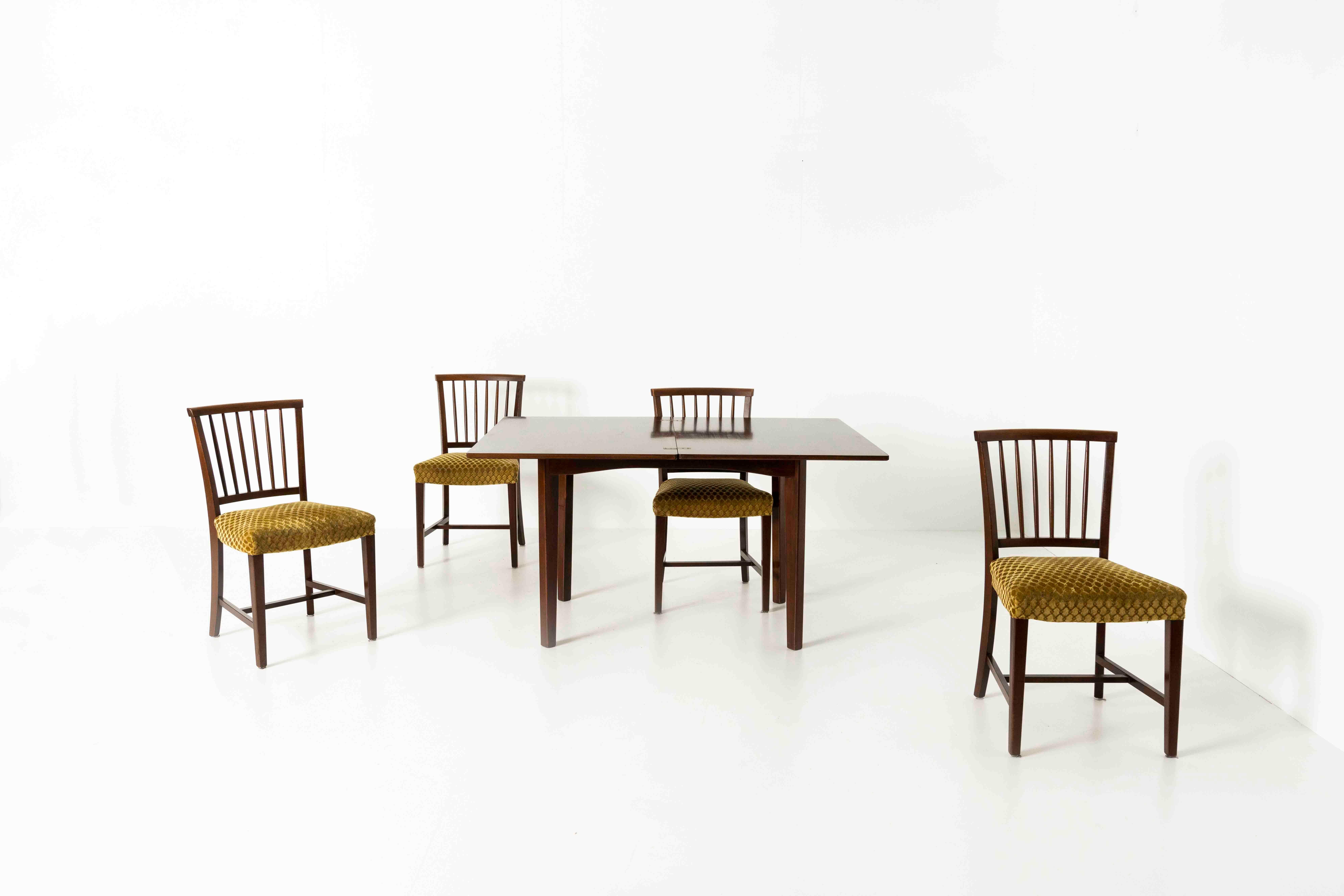 Nice set of four vintage dining chairs in wood and ocher yellow fabric, ca the 1960s. Although there is no clarity on the origin of these chairs, we feel it is a more traditional mid-century danish design. The chairs have a warm look and feel due to