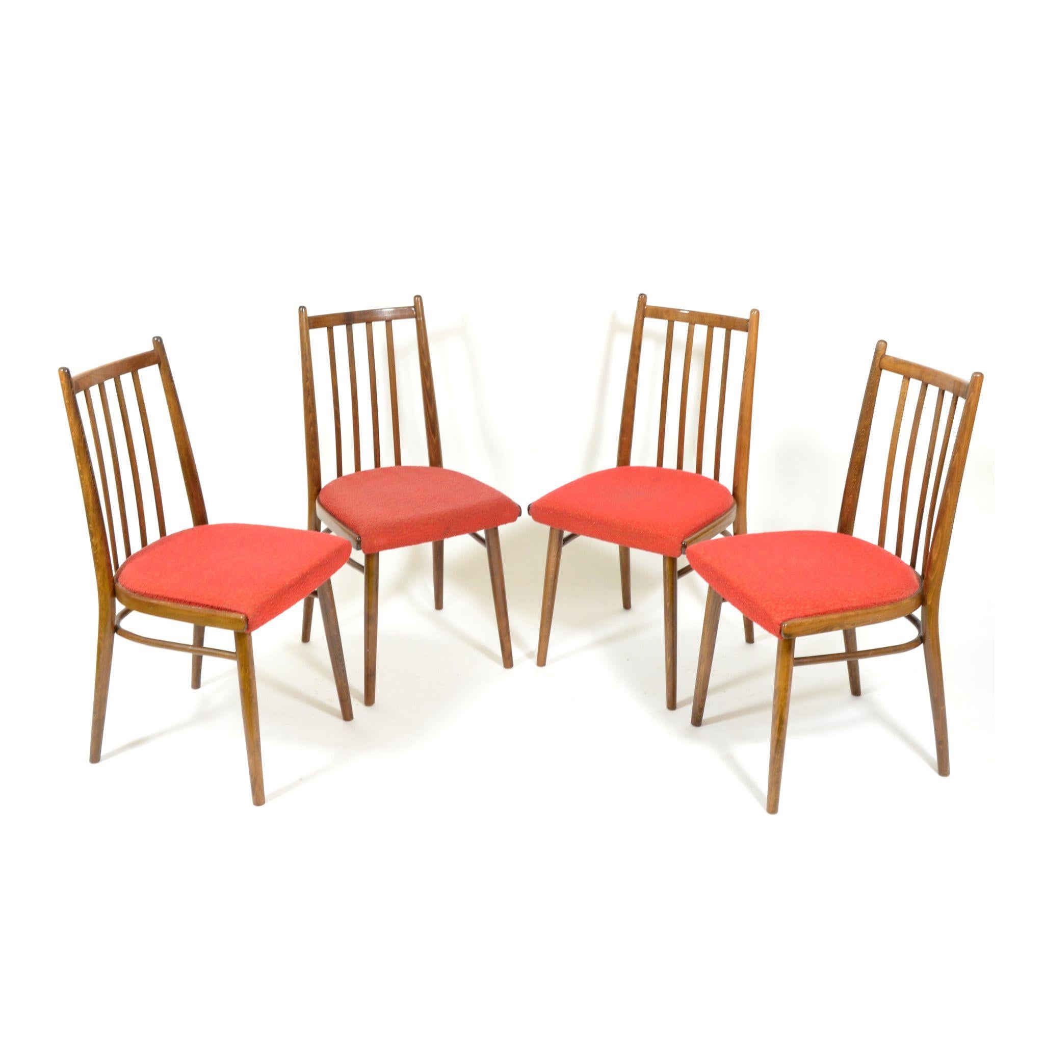 Set of four beech dining chairs in original, very good, condition. Chairs are stabile and can be used immediately. Wood very nice, with small signs of use. Red upholstery is also in good condition. Made in Czechoslovakia during 1970s.