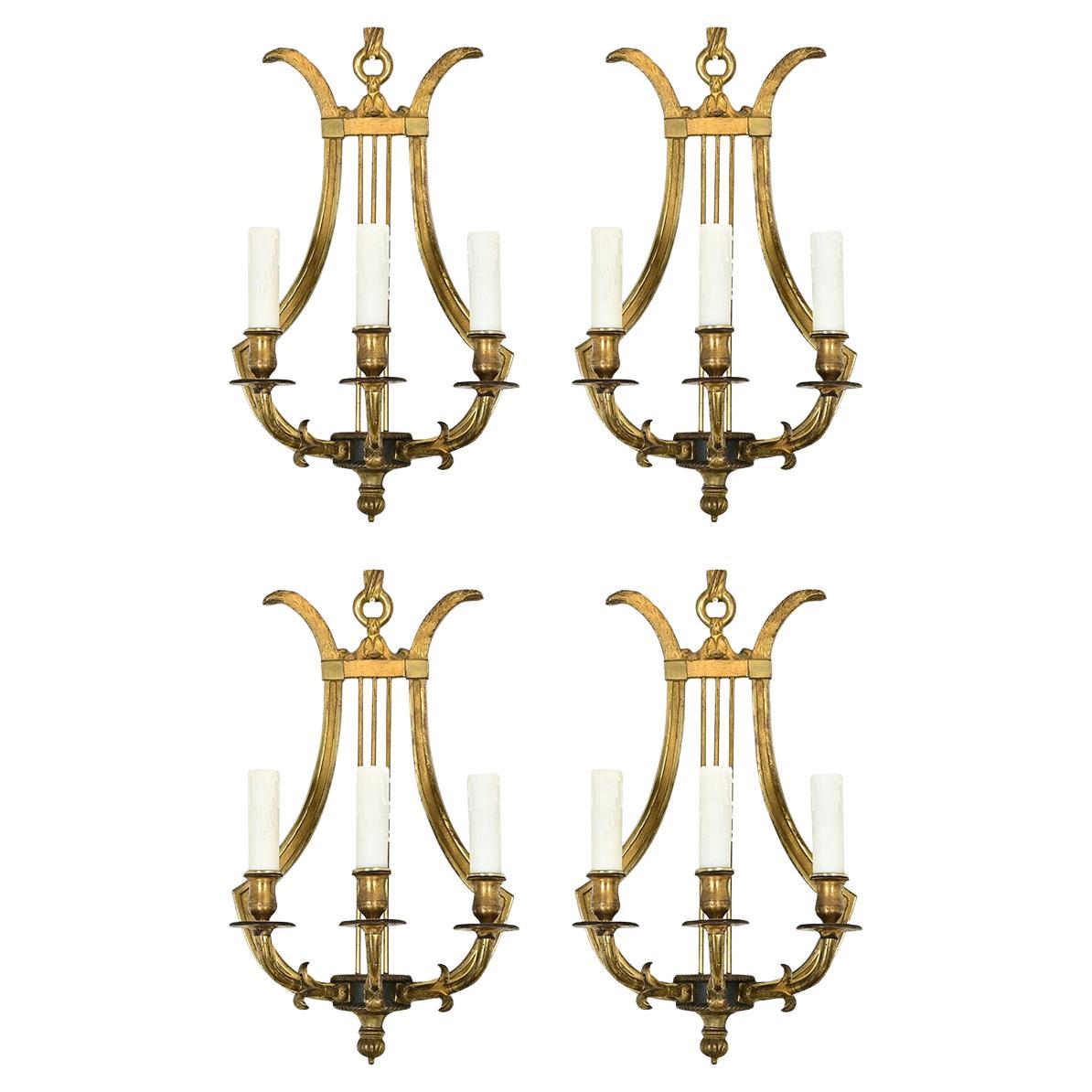 Ensemble de quatre appliques lyre en laiton d'époque française