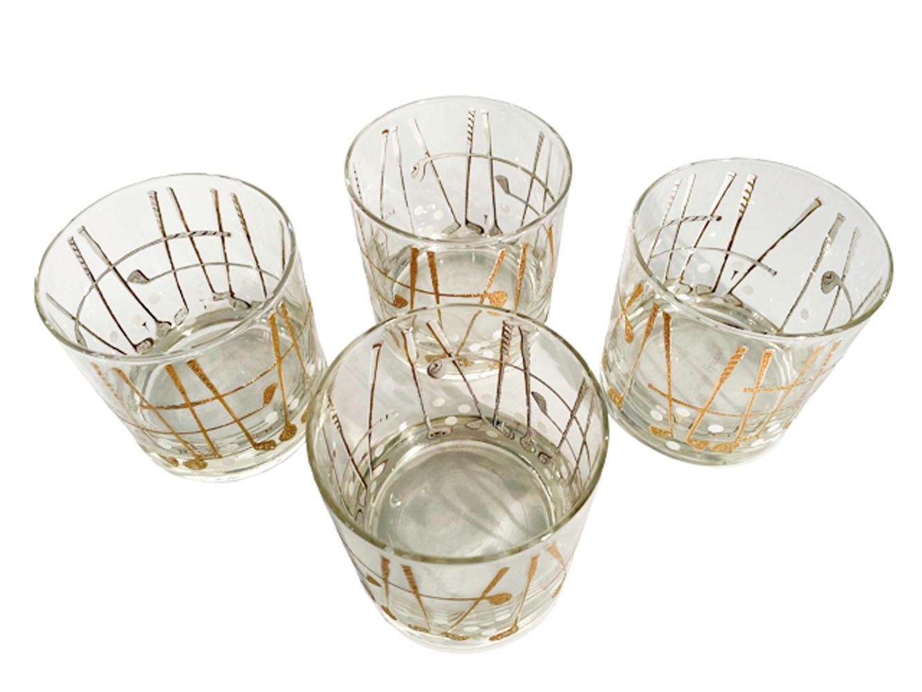 Four vintage Georges Briard golf theme glasses with raised white enamel clubs and balls, the clubs overlaid with 22 karat gold.
