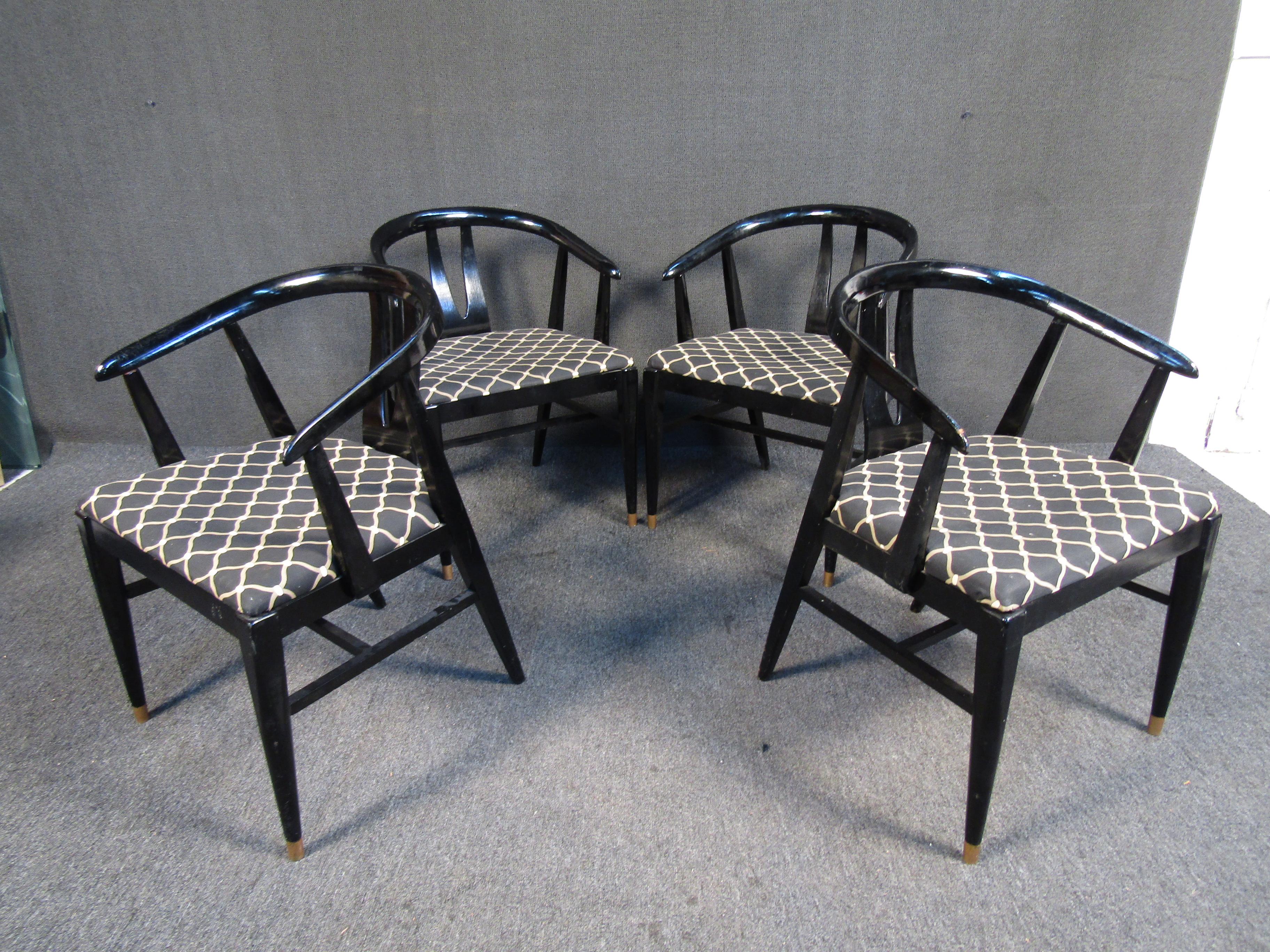 This vintage set of chairs combines an elegant black lacquered finish with patterned upholstery and brass footing. Please confirm item location with seller (NY/NJ).