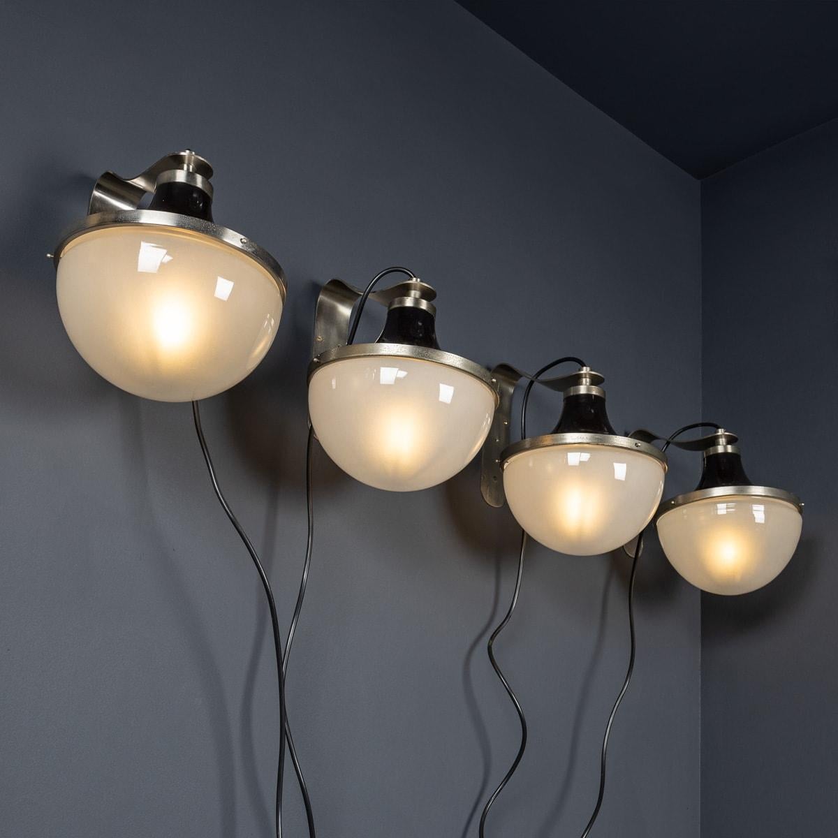 A superb set of four mid 20th Century Italian wall lights. These stylish lights showcase a blend of metal and black enamel complemented by white opaque glass shades, epitomising the essence of 1950's Italian design. Perfect for enhancing