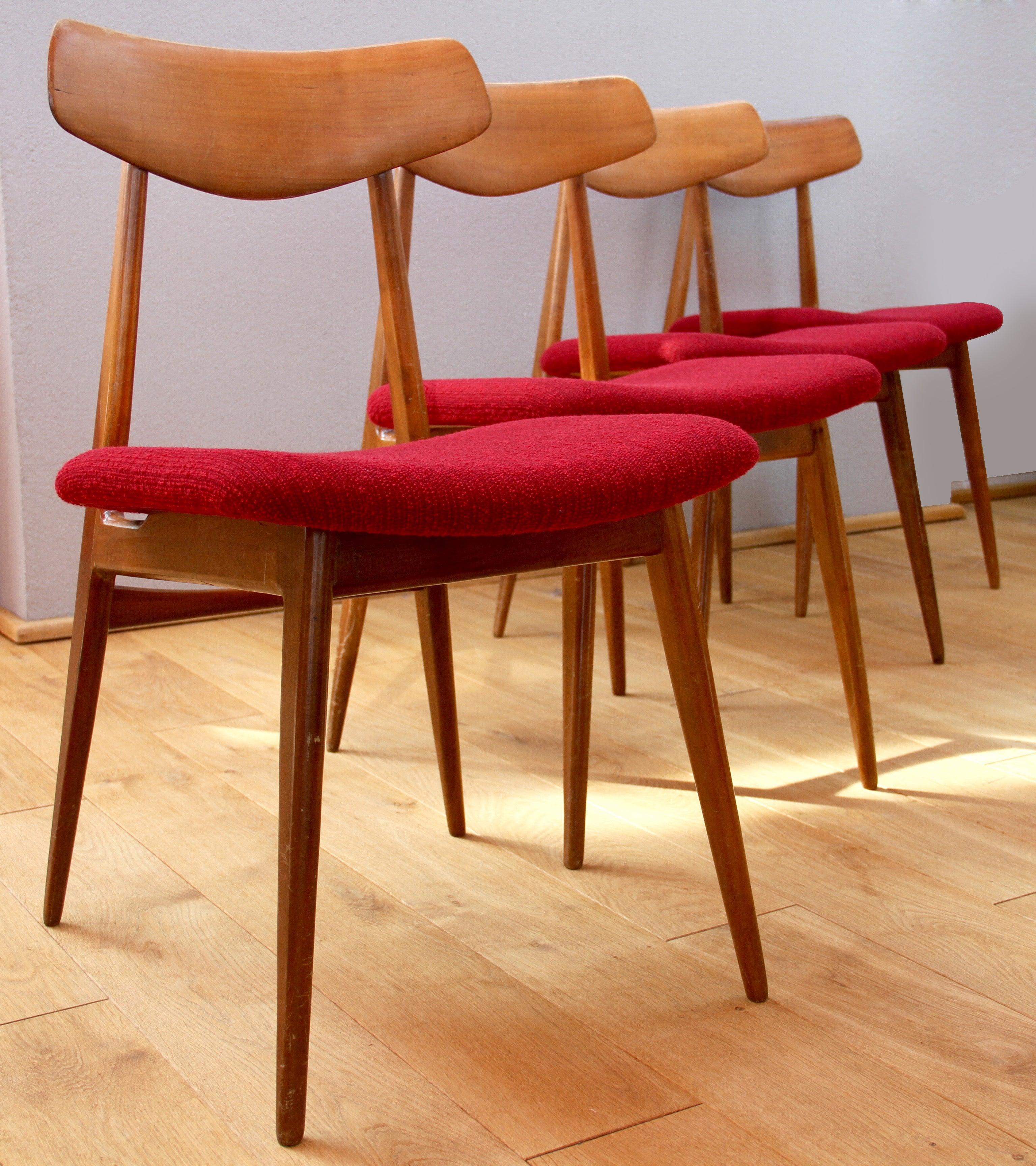 Hans Wegner style midcentury German made set of four dining chairs made by Habeo Möbel, circa 1954 complete with original red fabric.

These Habeo chairs also have a similar angles like the Wegner chairs to both the seat and backrest, making them