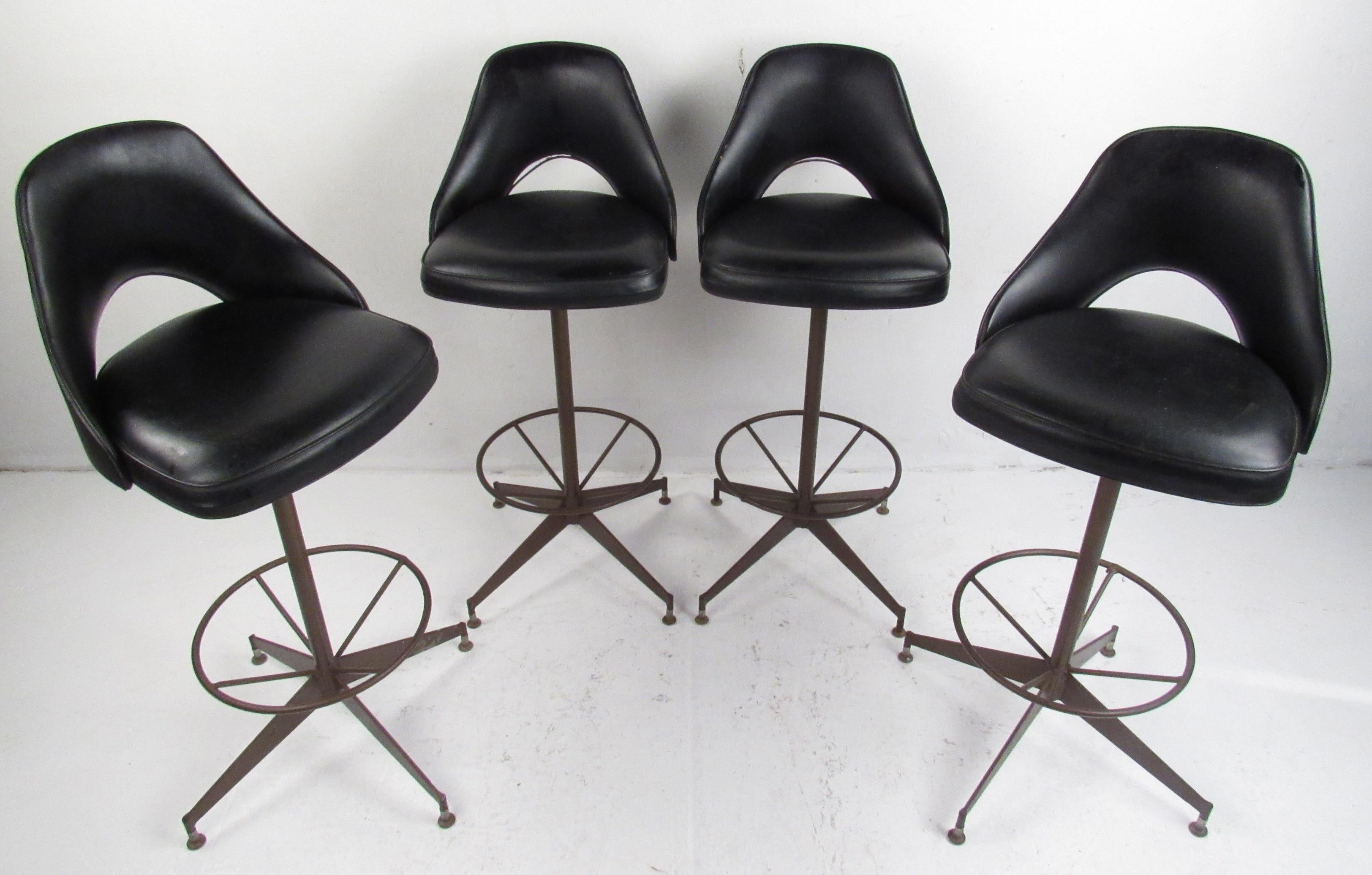 Great set of vintage stools by Antarenni Wrought Iron of Brooklyn, N.Y. These swivel stools have original vinyl seats/backs with a large circular foot rest above a four star base giving a very sculptural/industrial appearance. Please confirm item