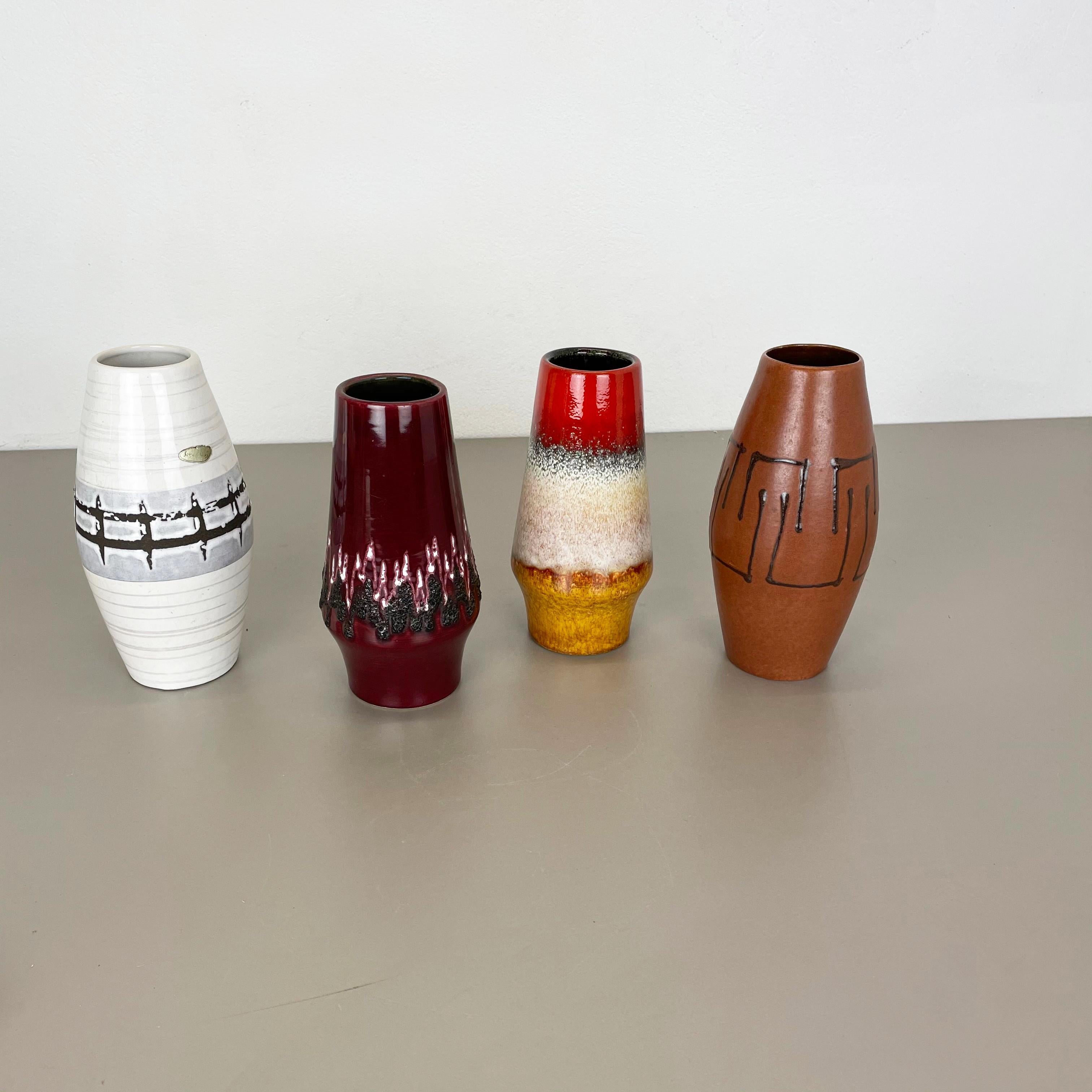 Article:

Set of four fat lava art vases

Producer:

Scheurich, Germany

Decade:

1970s

model:
309-20
248-22


These original vintage vases was produced in the 1970s in Germany. It is made of ceramic pottery in fat lava optic.