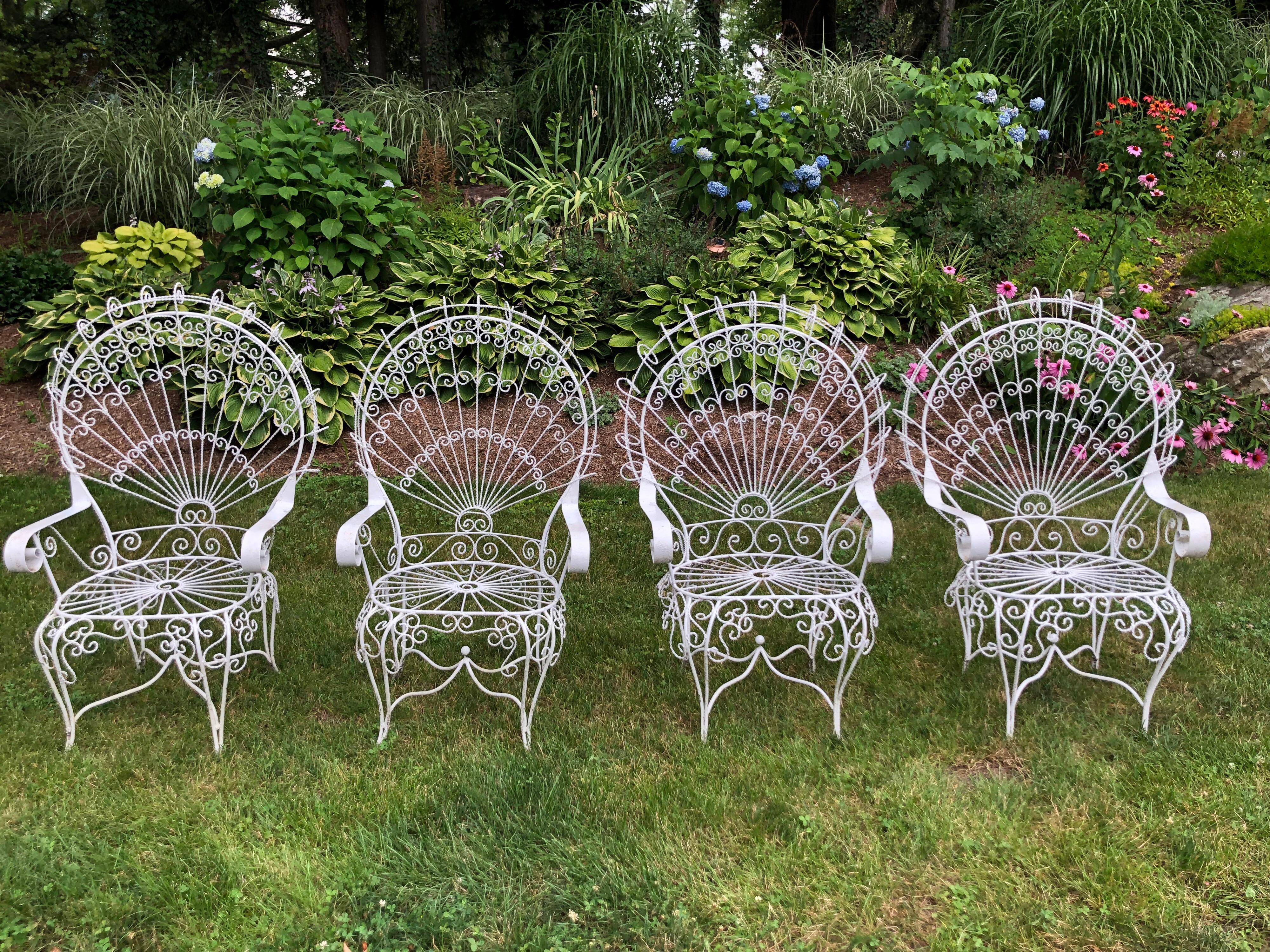 Set of four vintage Salterini white peacock chairs. Classic Hollywood Regency flamboyant style. Perfect for a garden or patio. Even use indoors for that indoor porch. Measure: Seat width is 21.
  