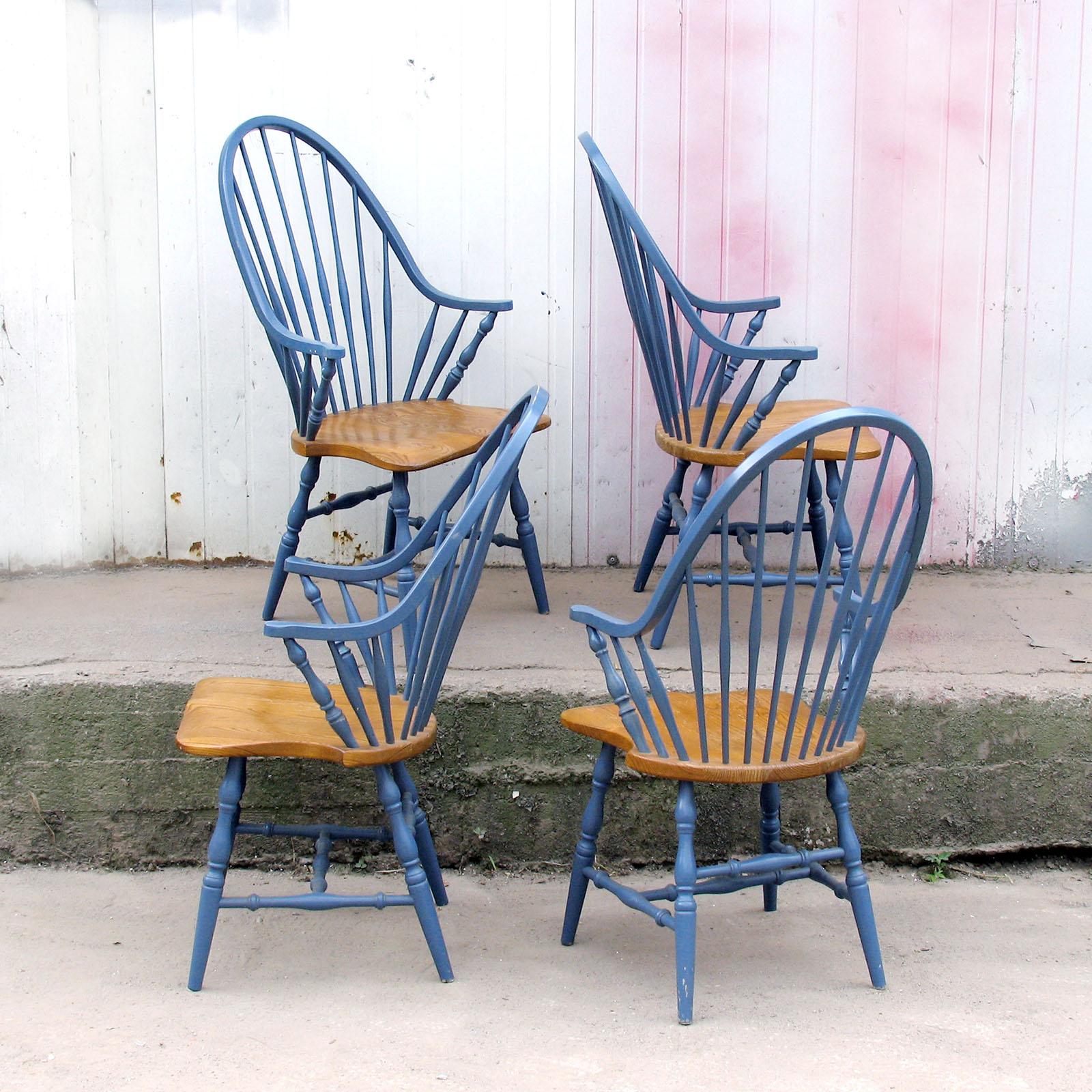 Set of four retro Windsor style armchairs with turned legs. The tall elongated arched back and the legs are blue painted. 
Really beautiful and extremely comfortable dining chairs in the style of Windsor. Made in Slovenia in 1990s at the Kli