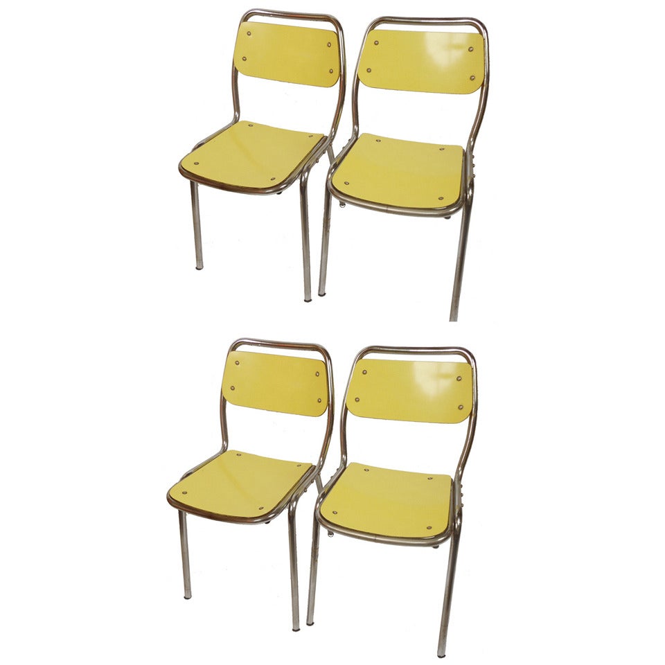 Set of four vintage yellow chairs, Italian manufacture, 1950's.
Polished metal structure and yellow laminate formica. 
These chairs are attributable to Gae Aulenti.
Each one measures cm 43x80 (H) - inches 16.92 x 31.49 (H).