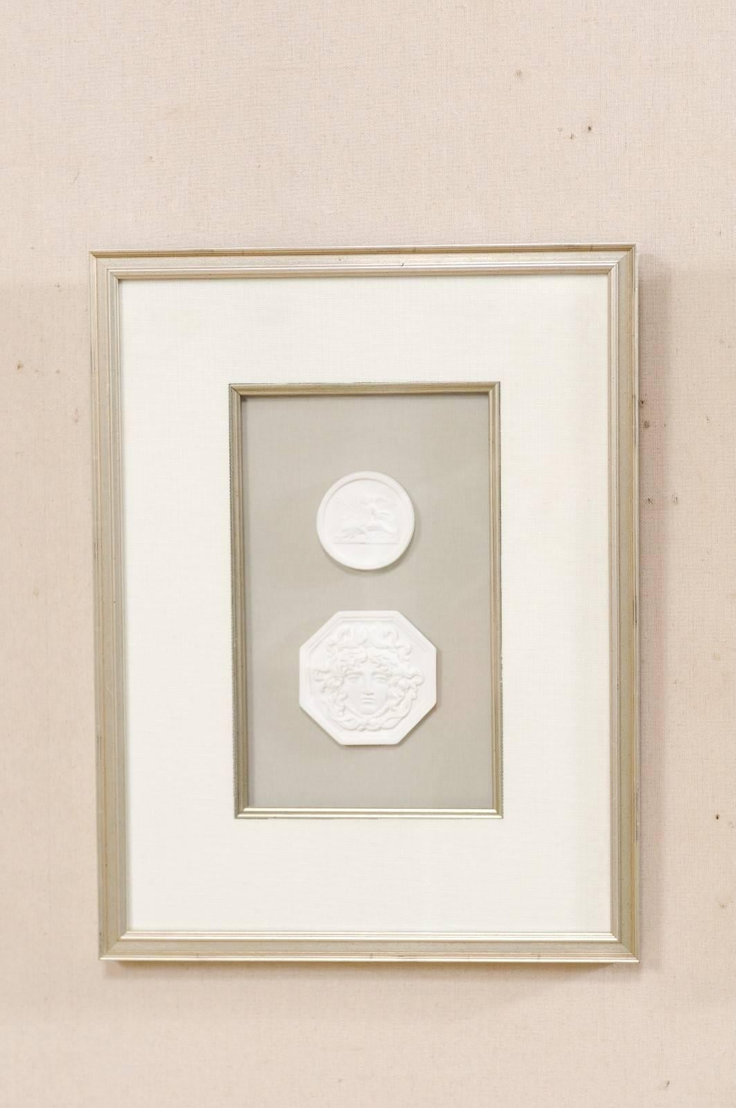 A collection of four framed assortment of white Italian intaglios. This is a set of hand-cast intaglios (from the original antique Italian Intaglios) which have been mounted and set within custom silver leafed frames. The details of these