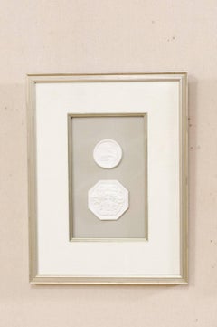 Set of Four Wall Decorations of Hand-Cast White Intaglios in Silver Leaf Frames