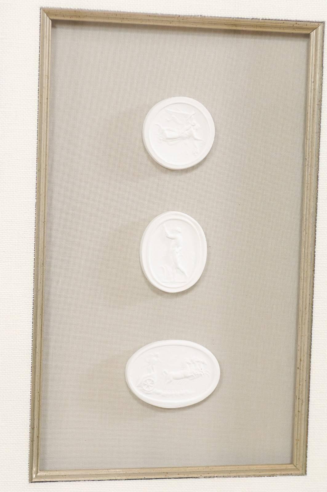 Contemporary Set of Four Wall Decorations of Hand-Cast White Intaglios in Silver Leaf Frames