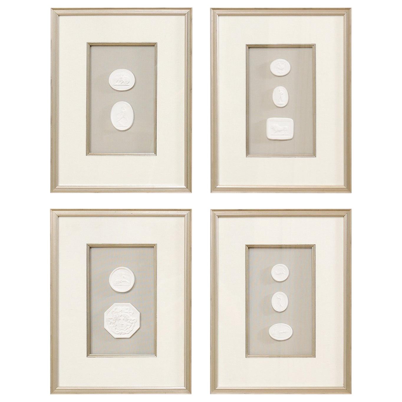 Set of Four Wall Decorations of Hand-Cast White Intaglios in Silver Leaf Frames