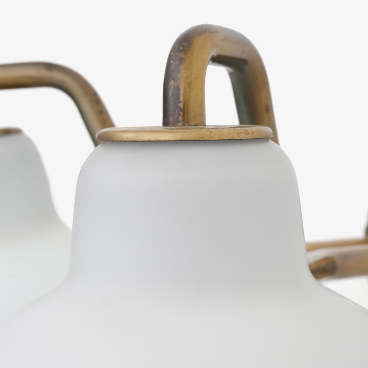 Two-armed wall lamp in brass with frosted opal glass. Vilhelm Lauritzen / Fog & Mørup.