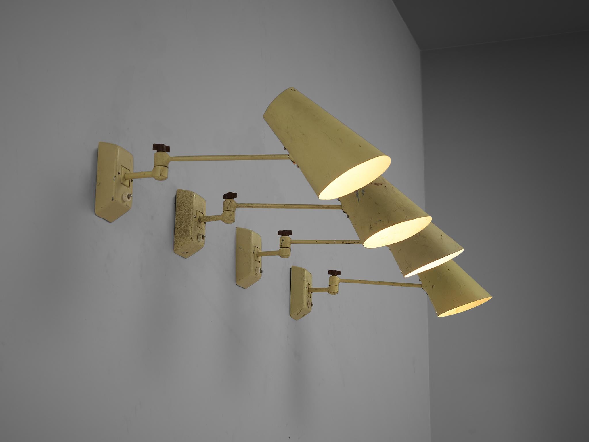 Set of four wall lights, lacquered metal, Europe, 1950s

Simple and sleek wall lights in pale yellow lacquered metal with adjustable rods and shades. The base of the lamps is attached to the wall and the light switch is located there. These lamps
