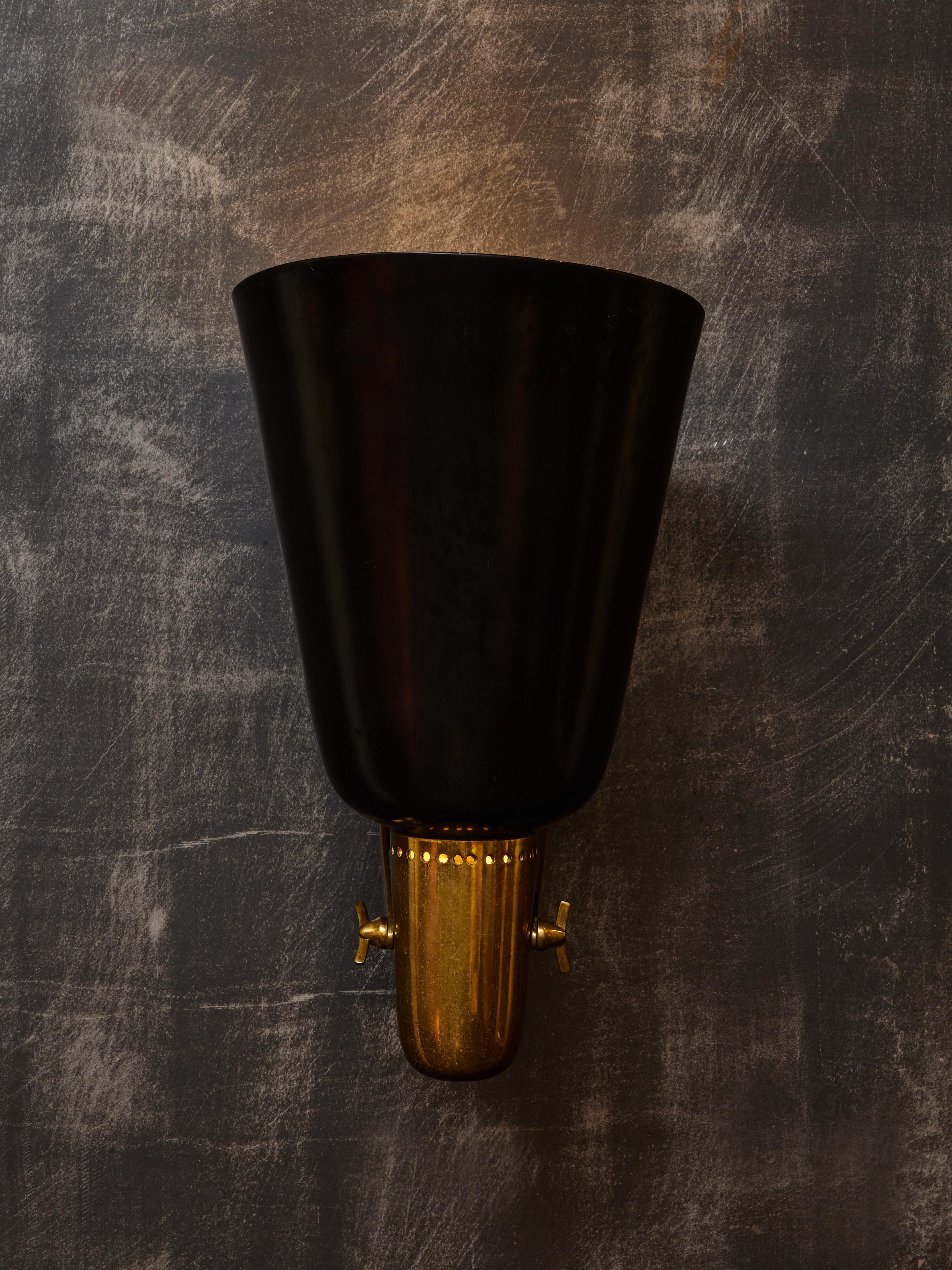 Pair of brass and painted metal wall sconces designed by Gino Sarfatti in 1946 for his lighting company Arteluce.

Originally a set of four, two sconces are now available. The displayed price is for the pair.