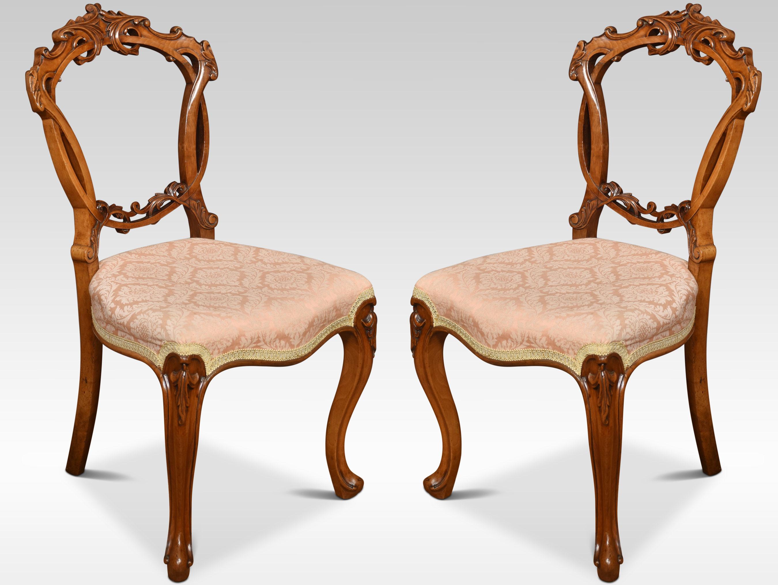 Set of four walnut balloon back dining chairs, each chair with an openwork ring back interlaced with carved scrolling foliate detail, above the overstuffed serpentine seat, raised up on cabriole front legs.
Dimensions
Height 35 inches height to