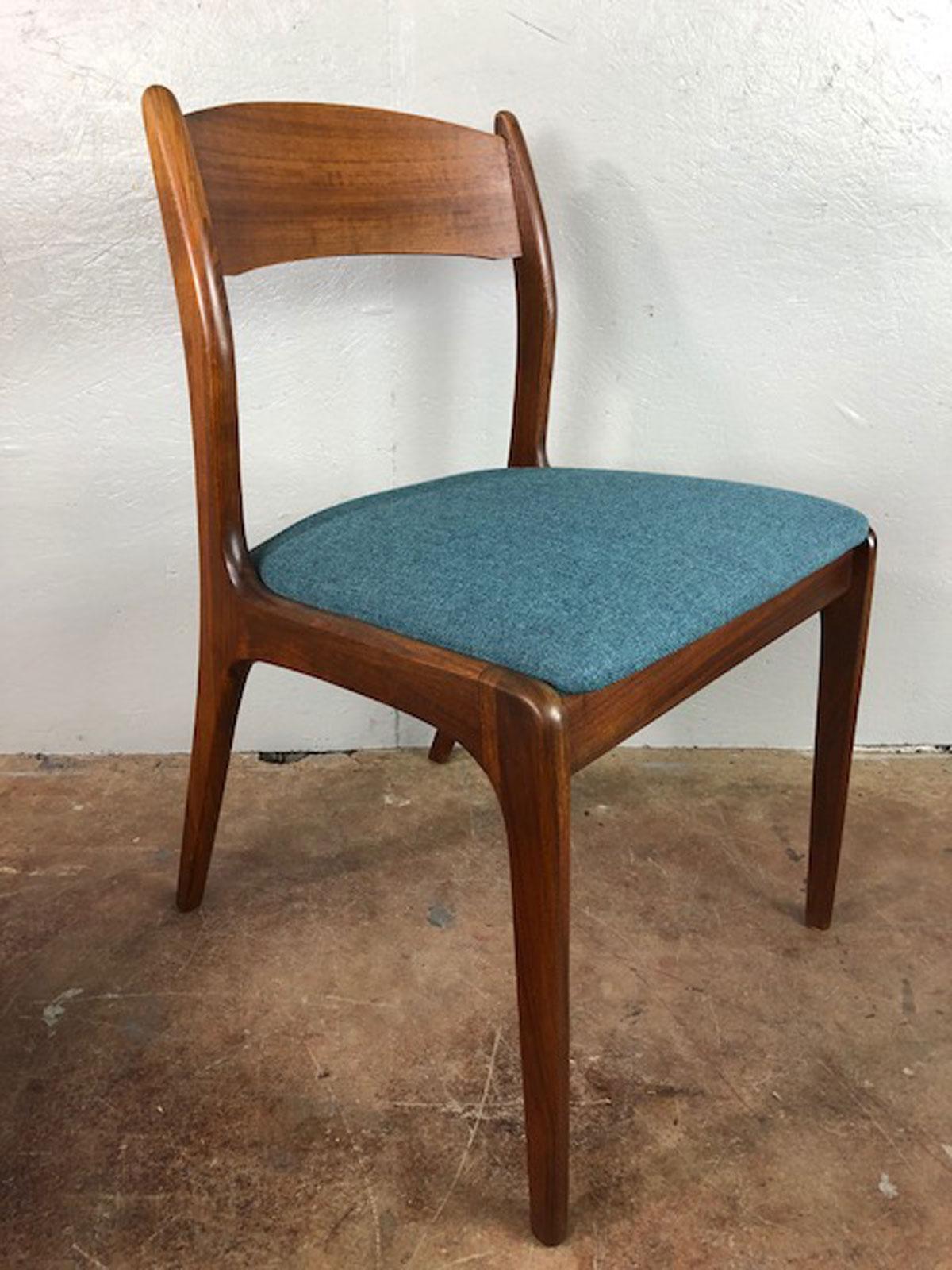 This set of four walnut dining chairs are attributed to J.L.Moller. Newly upholstered, circa 1960s. Very nice set. Rich and elegant.