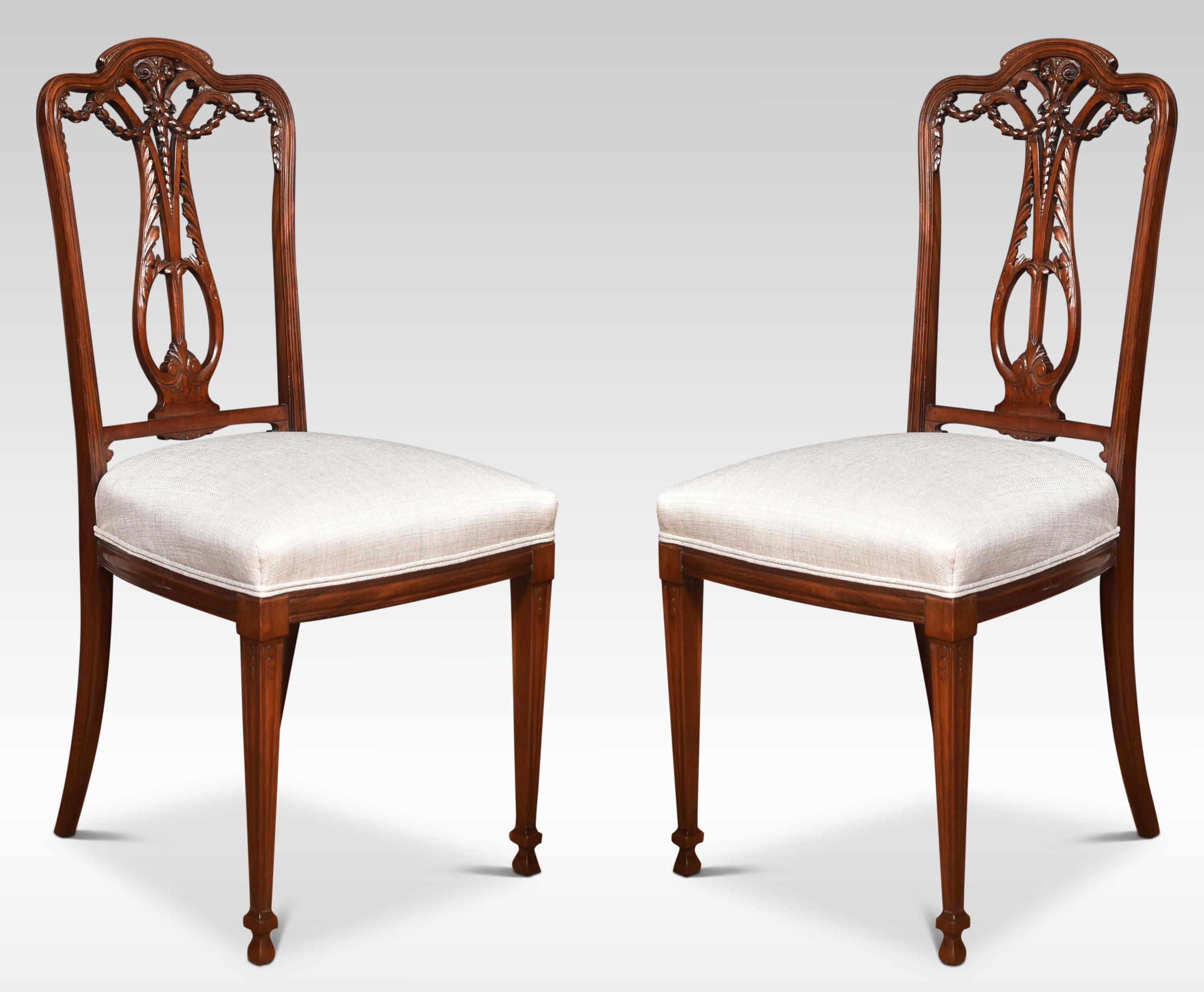 Set of four walnut dining chairs with carved-shaped pierced backrests over an upholstered seat All raised up on tapering legs.
Dimensions
Dimensions
Height 38.5 inches height to seat 19 inches
Width 18 inches
Depth 19 inches.