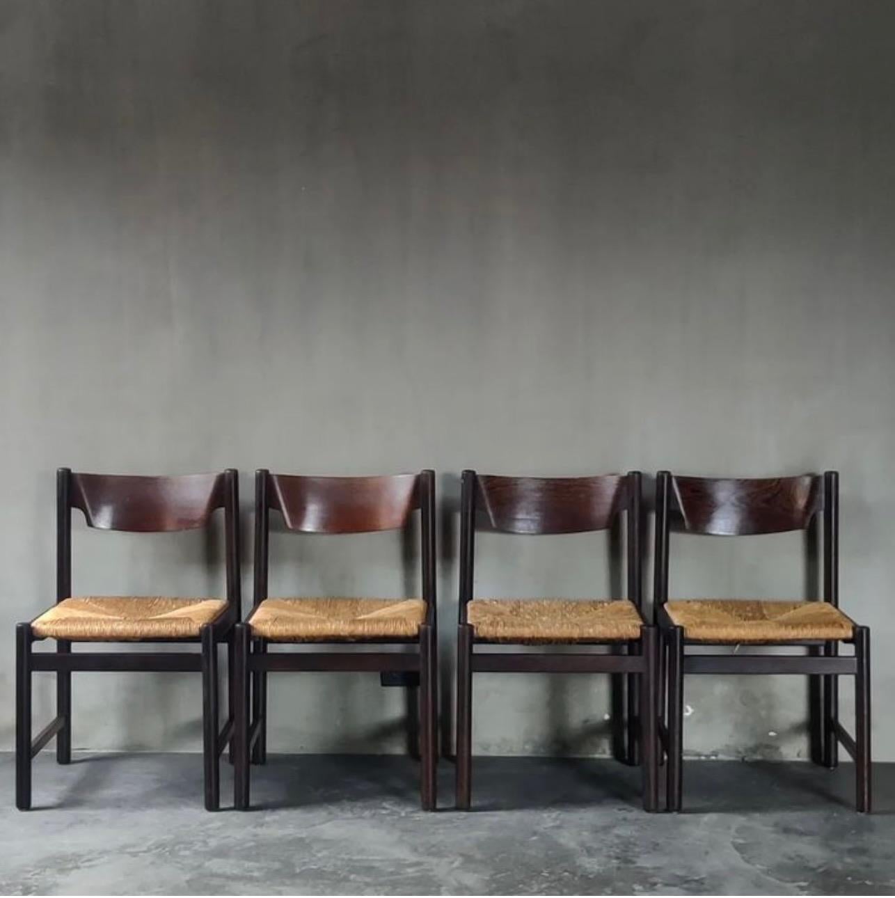 Set of four Dutch mid-century wenge (otherwise known as hardwood) dining chairs with woven rush seats, designed by Martin Visser for Spectrum. Chic and modern with a relaxed, 'lazy fancy' vibe. 

Netherlands, circa 1950

Dimensions: 18.5W x