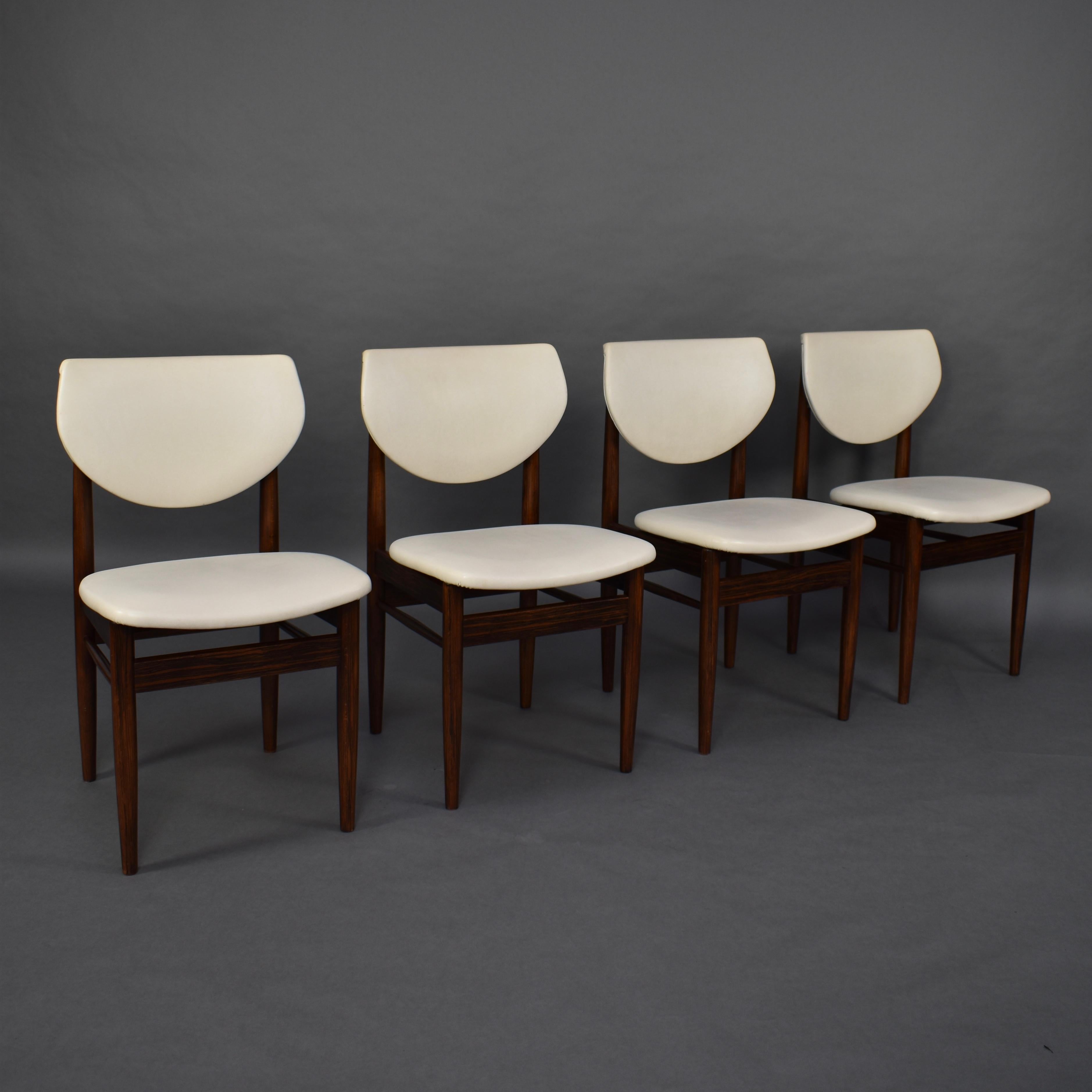 Set of 4 dining chairs in solid Wenge and creme faux leather. It is unusual to find chairs made of Wenge. It has beautiful black drawings in the wood.

Design: Unknown

Manufacturer: Unknown

Date of manufacture: circa 1950-1960

Model: