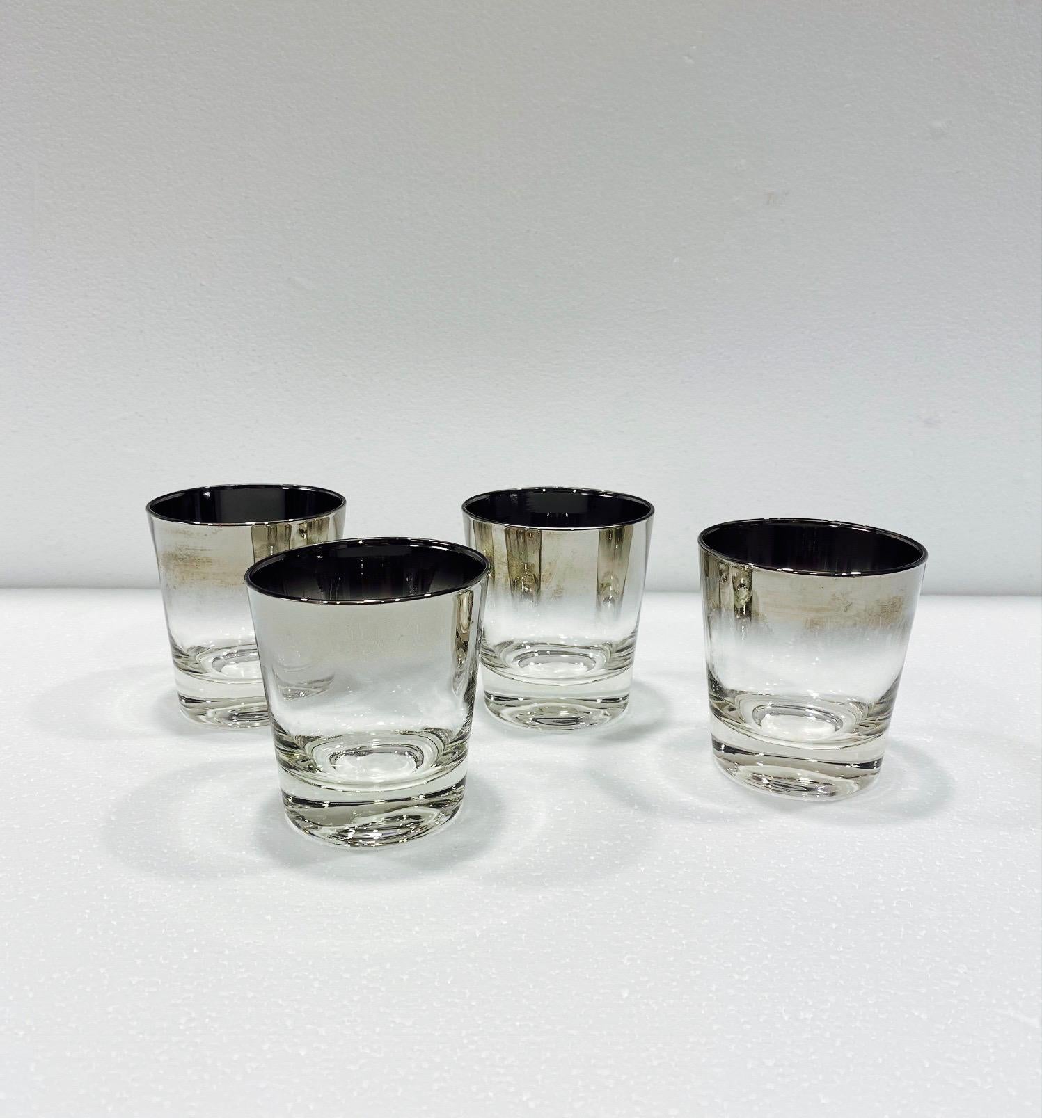 Iconic Mid-Century Modern barware glasses with silver fade overlay design. Great looking rock glasses with tapered forms and gradient rims with in ombre gunmetal. Makes a smart and handsome addition to any barware collection. 
 
 