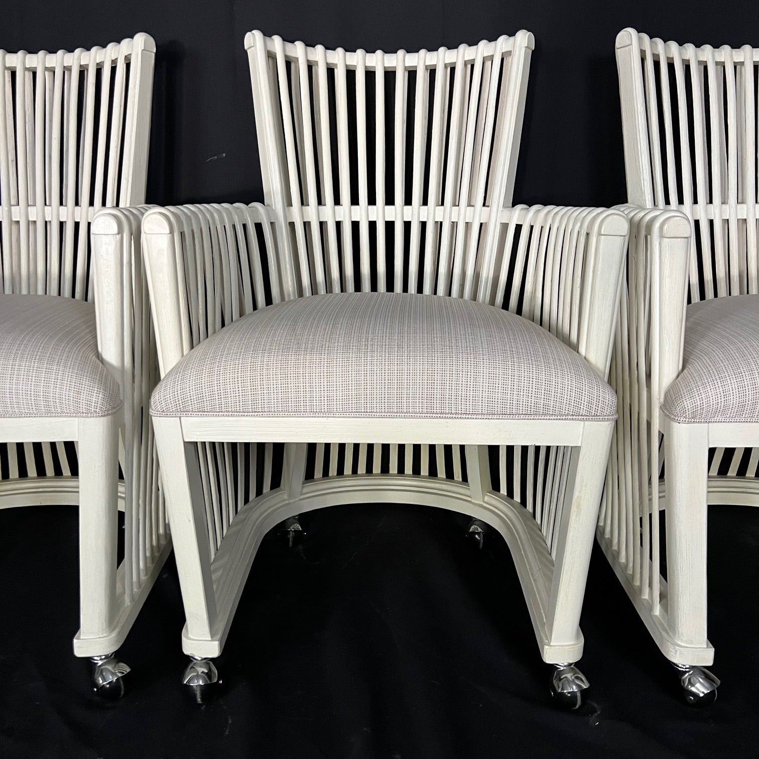 Elegant and traditional yet contemporary chic set of bent rattan dining or side chairs on casters. Each chair is super comfortable and sturdy, with mortise and tenon construction. Strong case backs are recessed into each end, with a well mounted top
