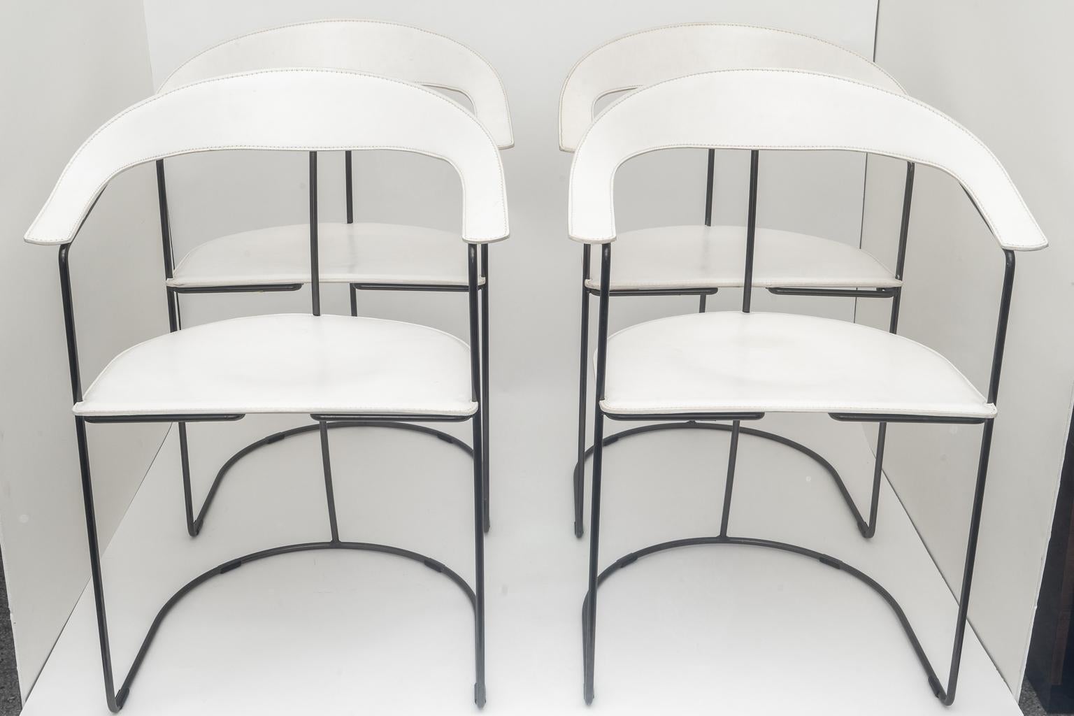 These four slope-backed armchairs in white leather were created by Arrben in the 1980s-1990s. The chairs are very simple in design and have a great sculptural presence. 

Note: The tubular frames are solid and in a polished gun-metal finish.