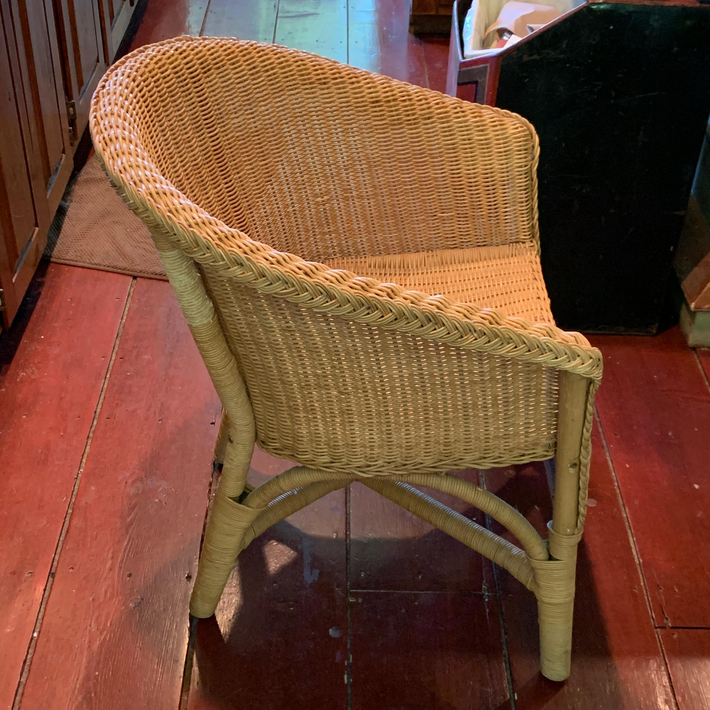 Contemporary set of four wicker curved back dining chairs.
Slight color variance on the back frame of one of the chairs.