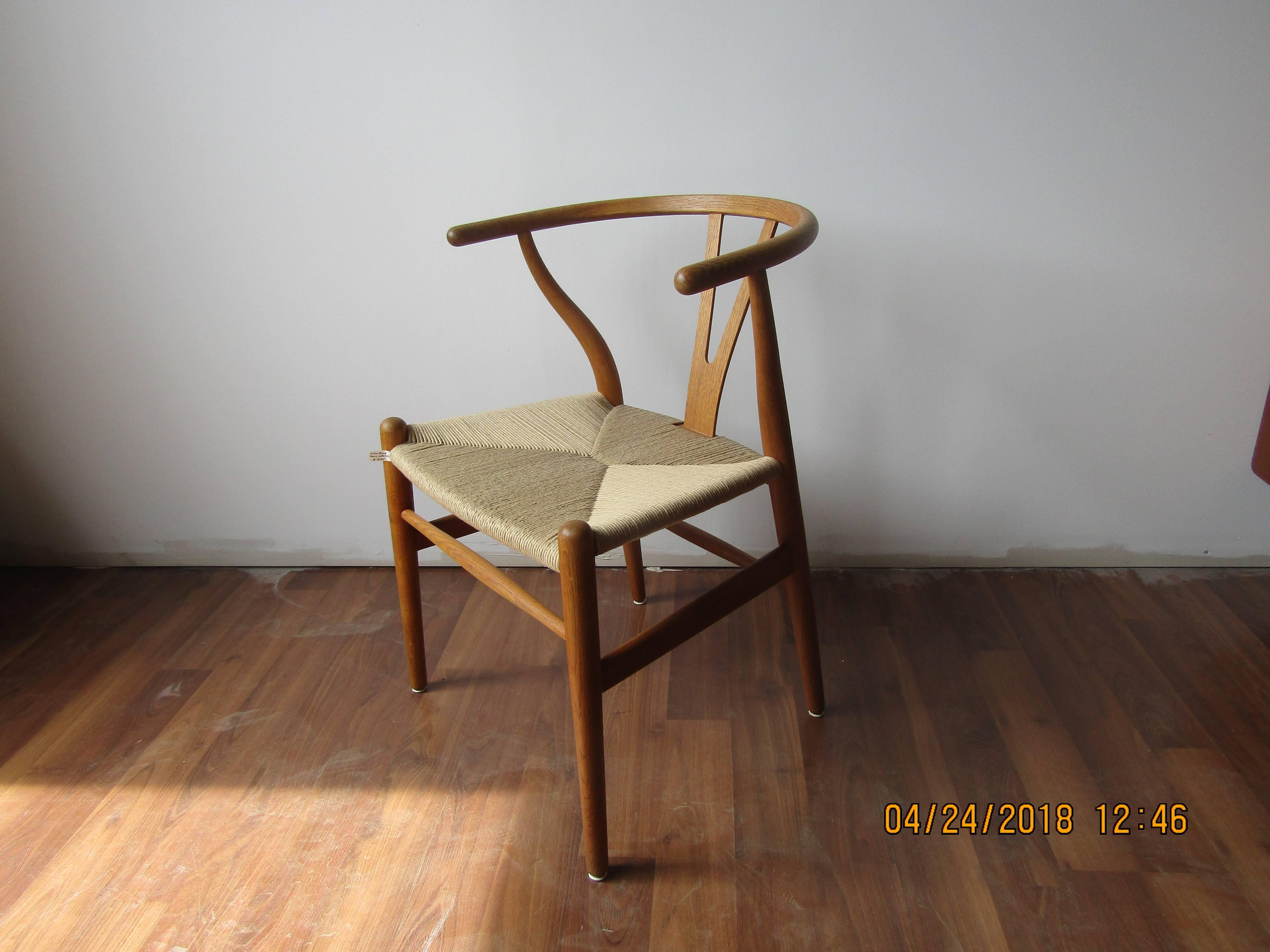 Set of four wishbone chairs by Hans Wegner in white oak and papercord.