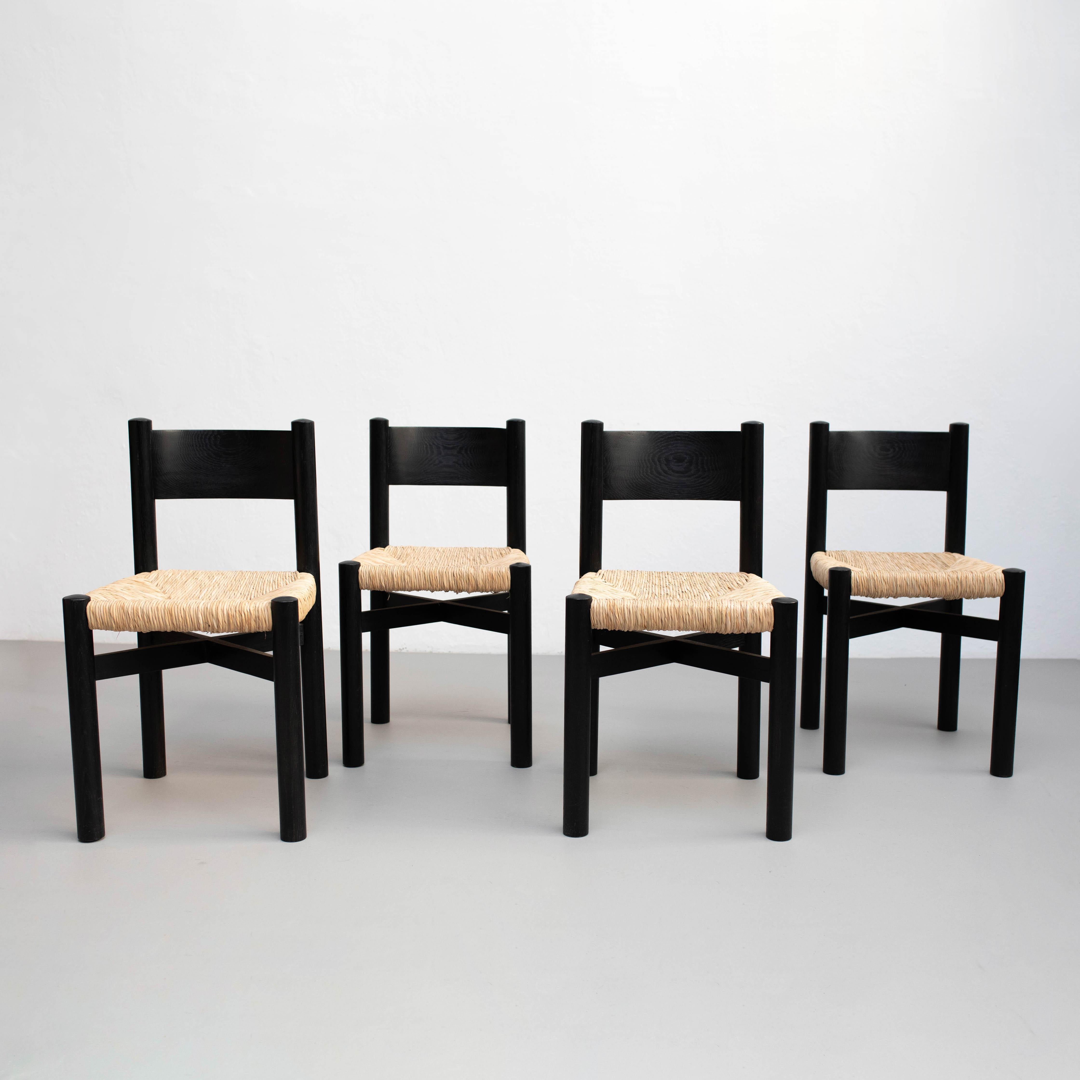 Set of four wood and rattan chairs after Charlotte Perriand, circa 1980.

Unknow manufacturer.

In good original condition, with minor wear consistent with age and use, preserving a beautiful patina.

Materials:
Wood
Rattan

Cane has been