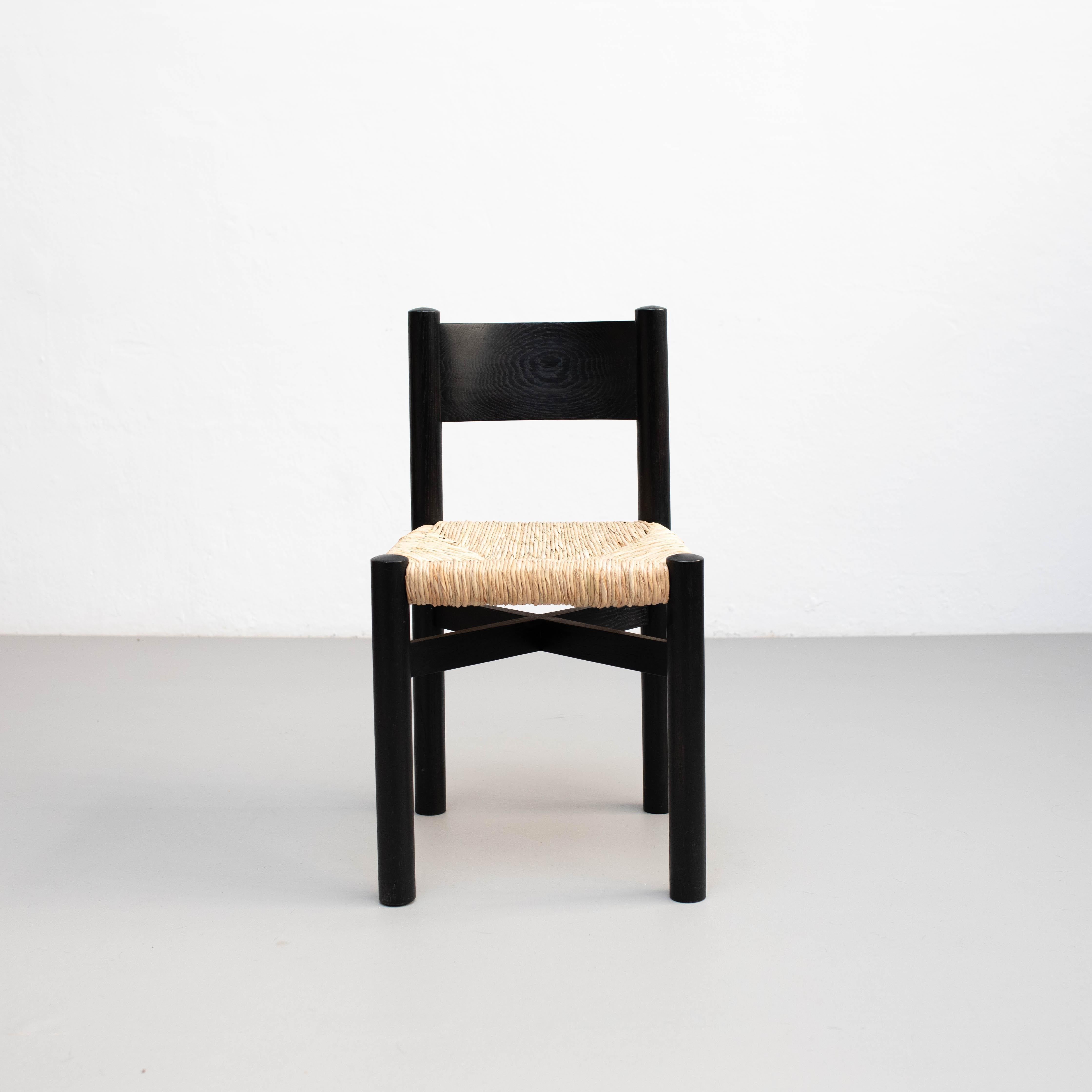Bois Ensemble de quatre chaises en bois et rotin d'après Charlotte Perriand - Circa 1980 en vente