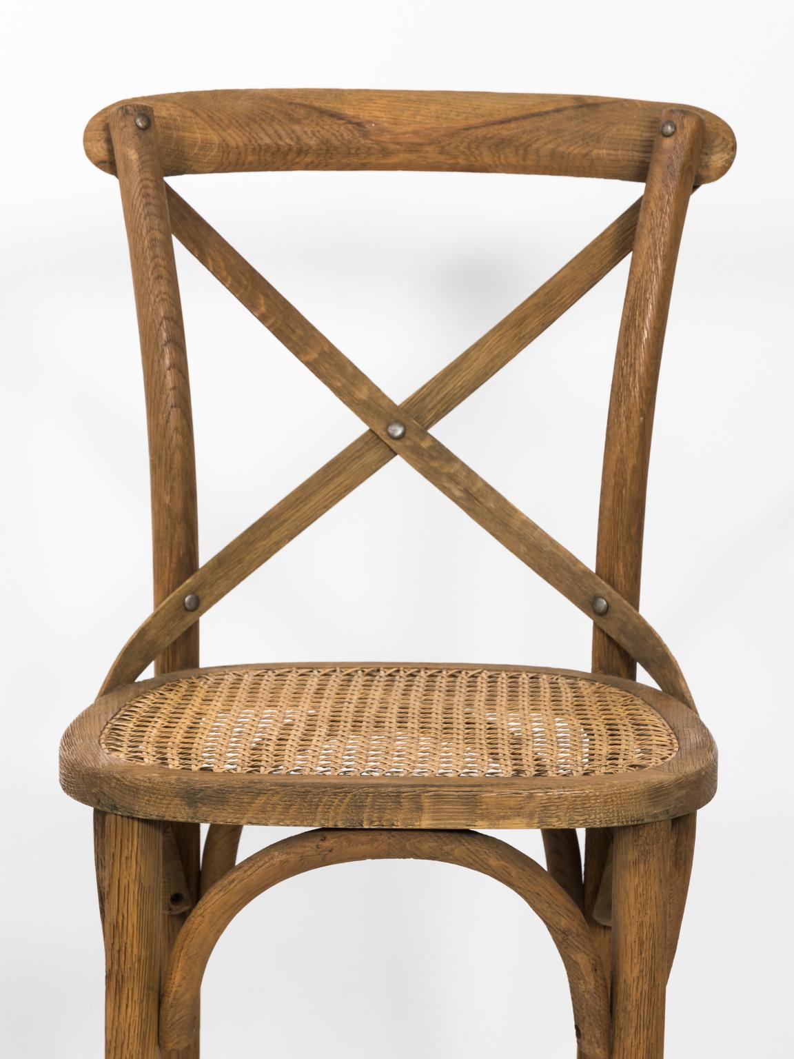 Set of four vintage unfinished wood bar stools with cane woven seating. Please note of wear consistent with age.
  