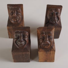Set of Four Wood Carved Corbels with Grotesque Faces