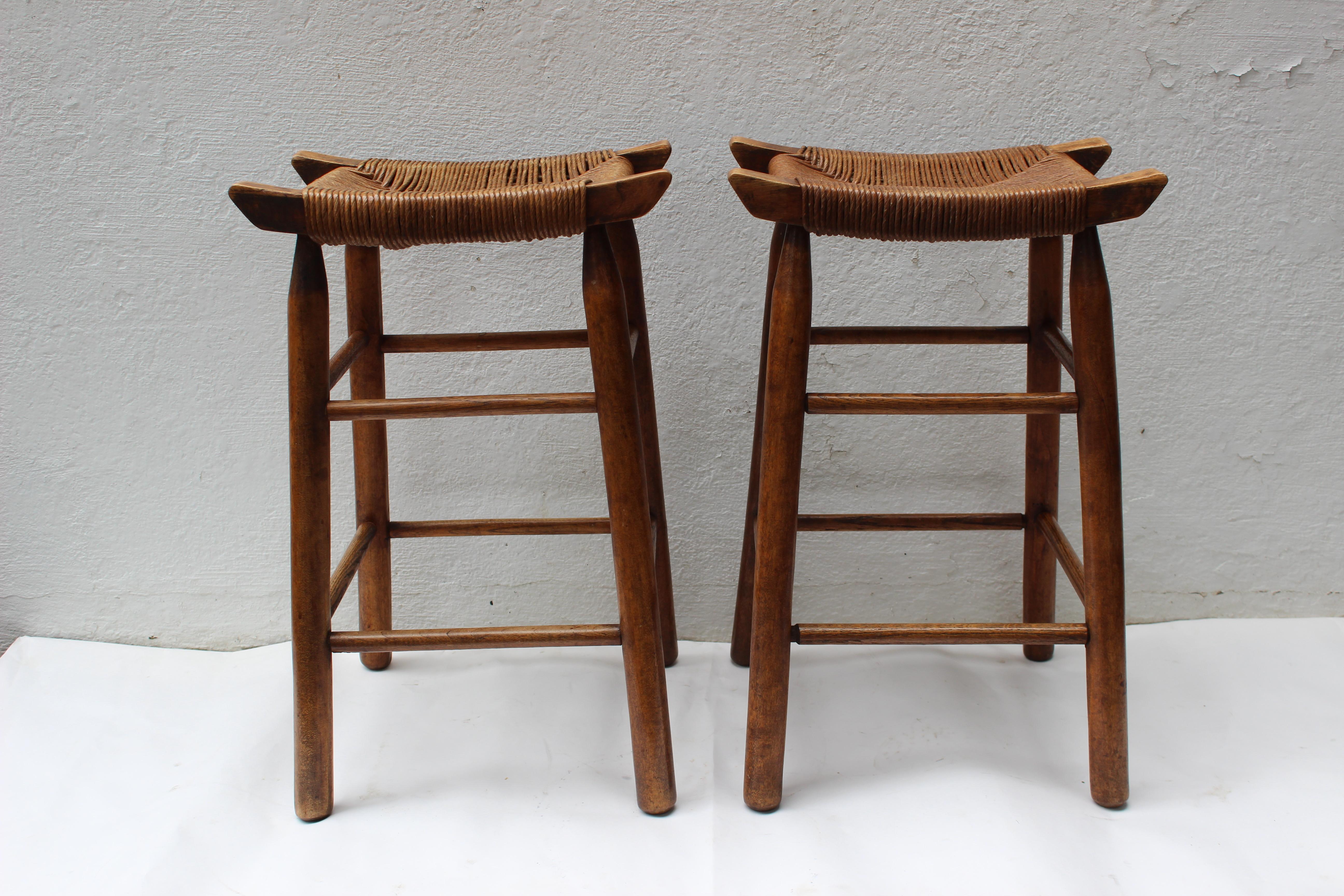 Set of four Charlotte Perriand style wood stools with rush seats.