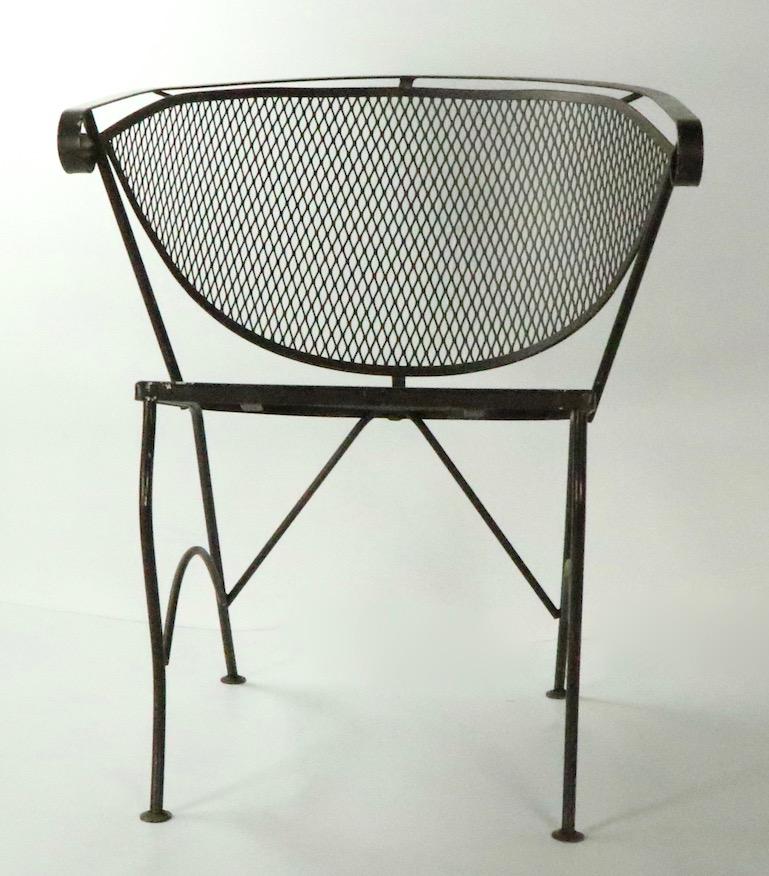 Set of 4 modernist outdoor chairs patio chairs, attributed to Woodard. These chairs are in very good condition, free of breaks, bends or repairs, currently in later brown paint finish. Usable as is, or we offer custom powder coating if you prefer a
