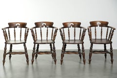 Set of four wooden English antique pub/captain chairs from the 19th century