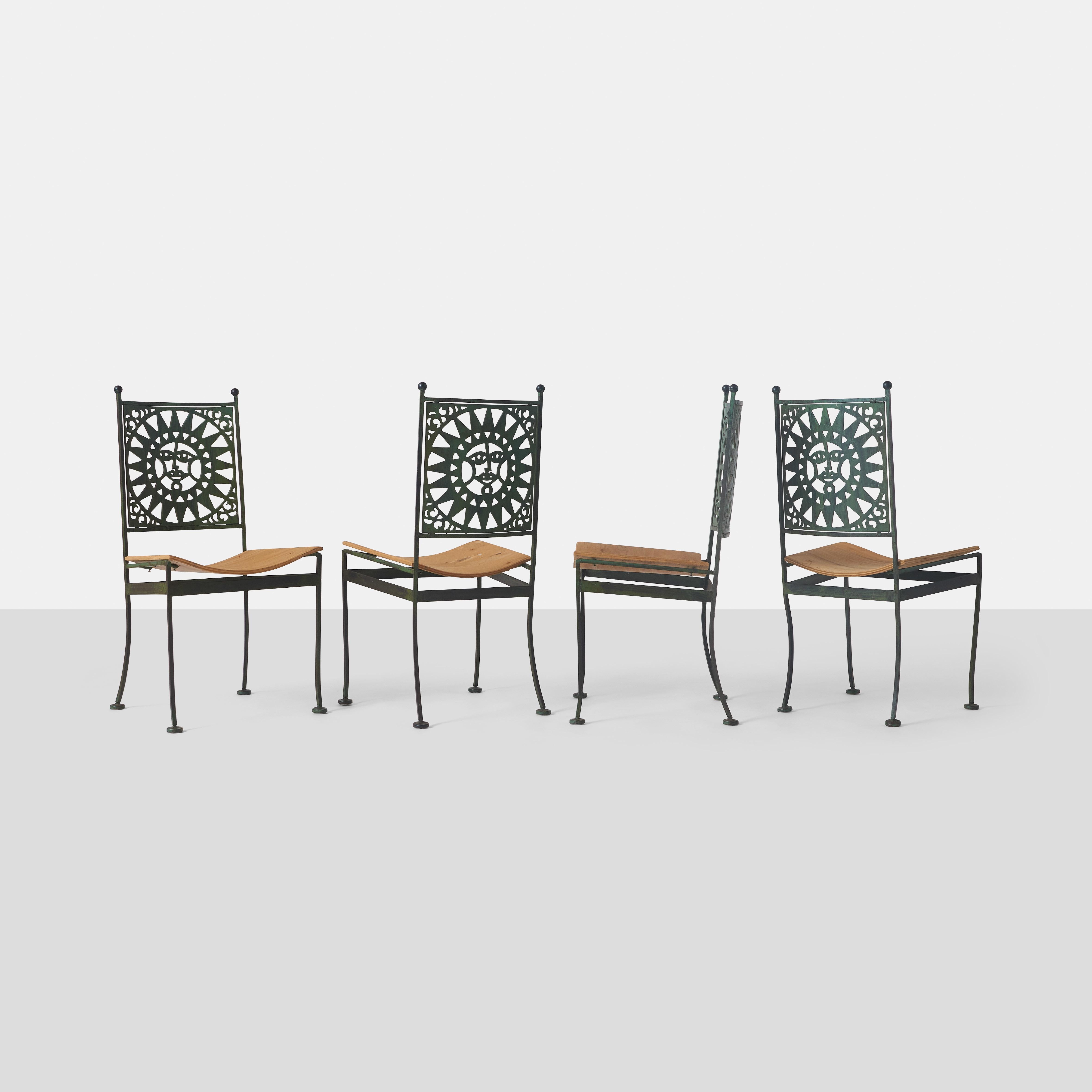 This set of four armless dining chairs were designed by Arthur Umanoff, a prominent American furniture designer known for his innovative use of mixed materials such as metal, wood, and rattan. The chairs are part of Umanoff's Mayan collection and