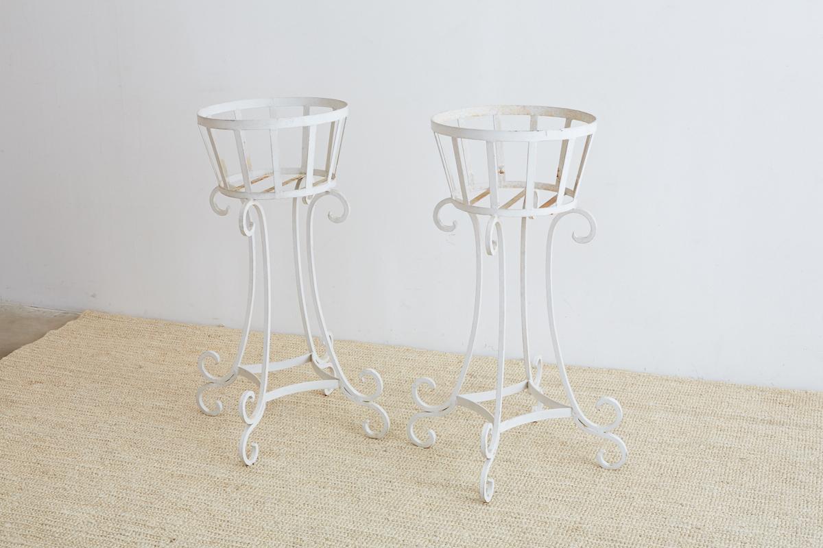 Matched set of four painted planters or plant stands made of wrought iron. Featuring 15