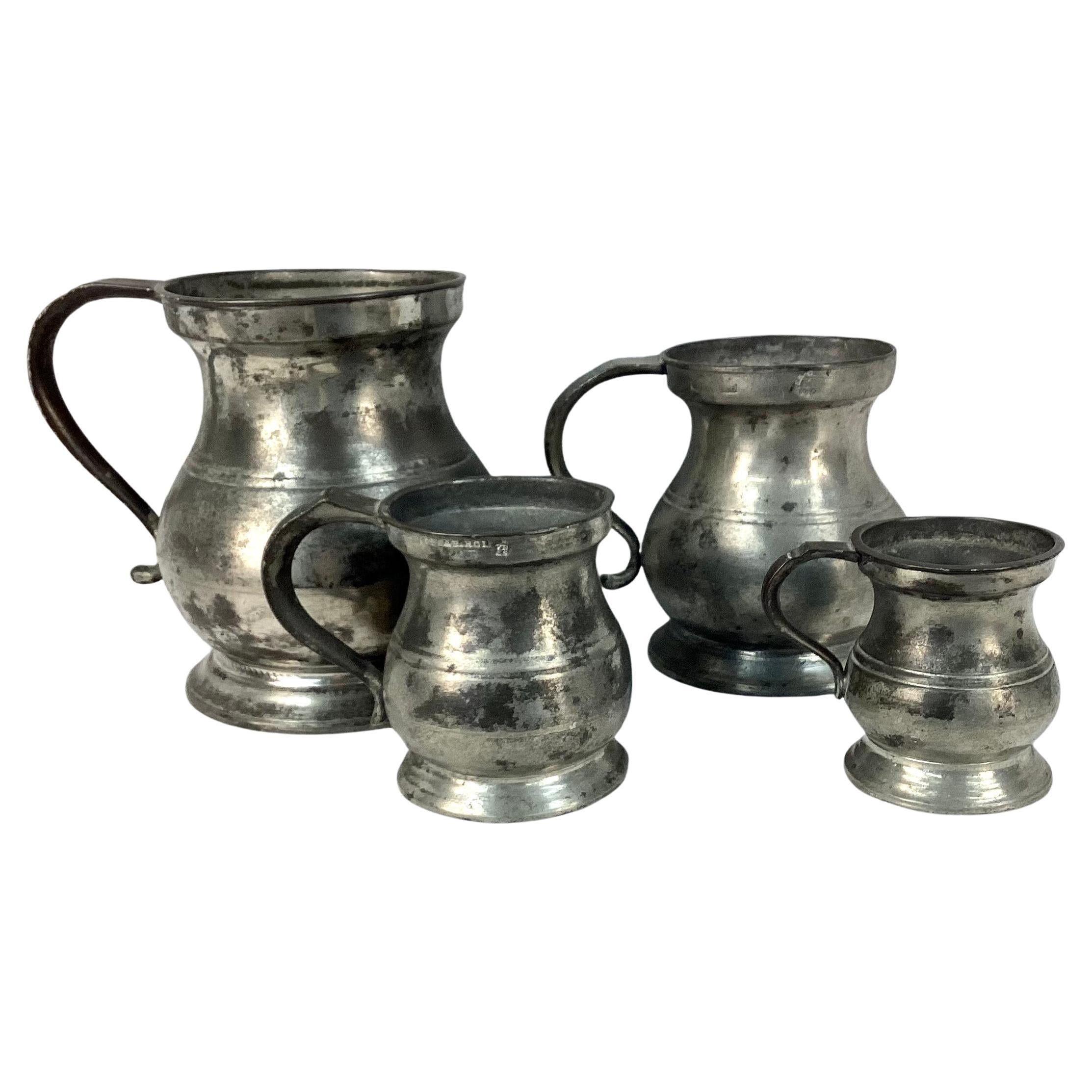 Set off four 19th century Yates & Birch pewter pitchers with pewter handles. Two are clearly stamped with Yates & Birch marking, also have Queen Victoria certification marks. Etched on all four undersides is name 'Colodny'.  Wonderful old patina. 