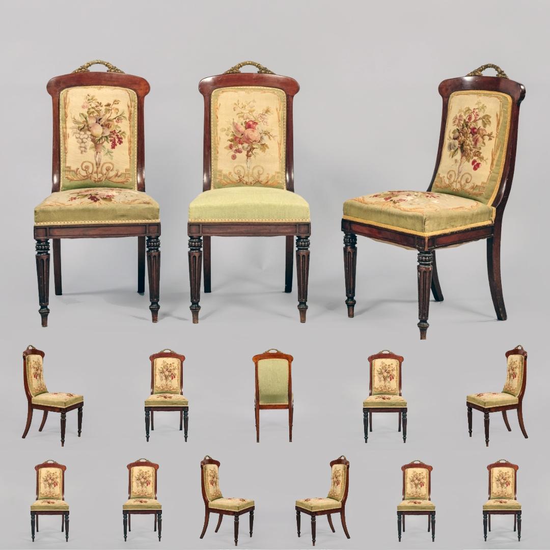A fine set of fourteen gilt bronze mounted mahogany dining chairs attributed to Jeanselme.

The floral tapestry to the back of each chair is in superb condition, of good design and with fine colors; two chairs retain their original tapestry