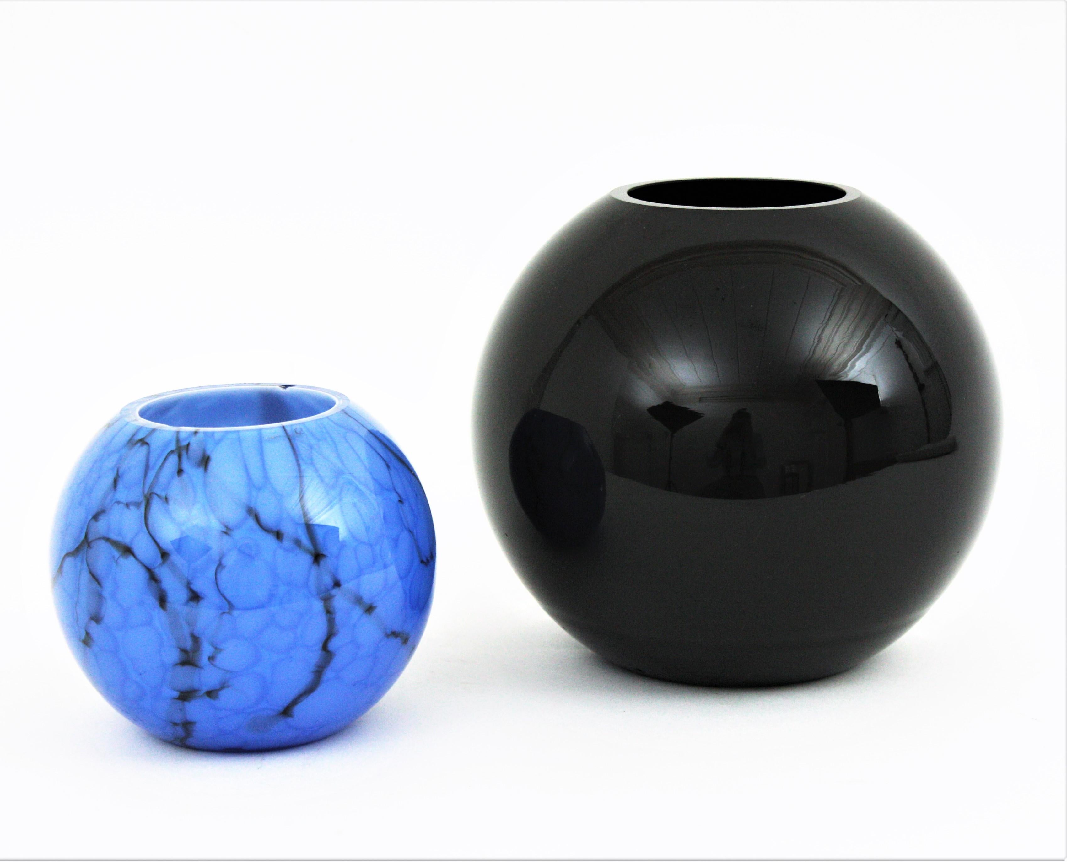 Set of two Round Shaped Murano Glass Vases, Italy, 1940s-1960s.
The small one is a ball shaped hand blown lattimo blue Murano glass vase attributed to Fratelli Toso for Venini, Italy 1940s.
This lovely sphere vase is made with lattimo or milk