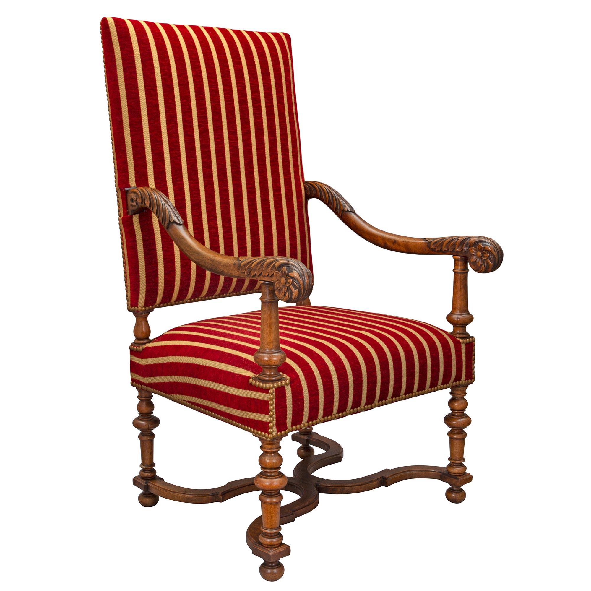 A handsome set of four French mid 19th century Louis XIII st. carved oak armchairs, signed Gillette, circa. 1840 . Each armchair is raised by turned legs joined by a curved X stretcher. The scrolled arms are richly detailed with carvings of acanthus
