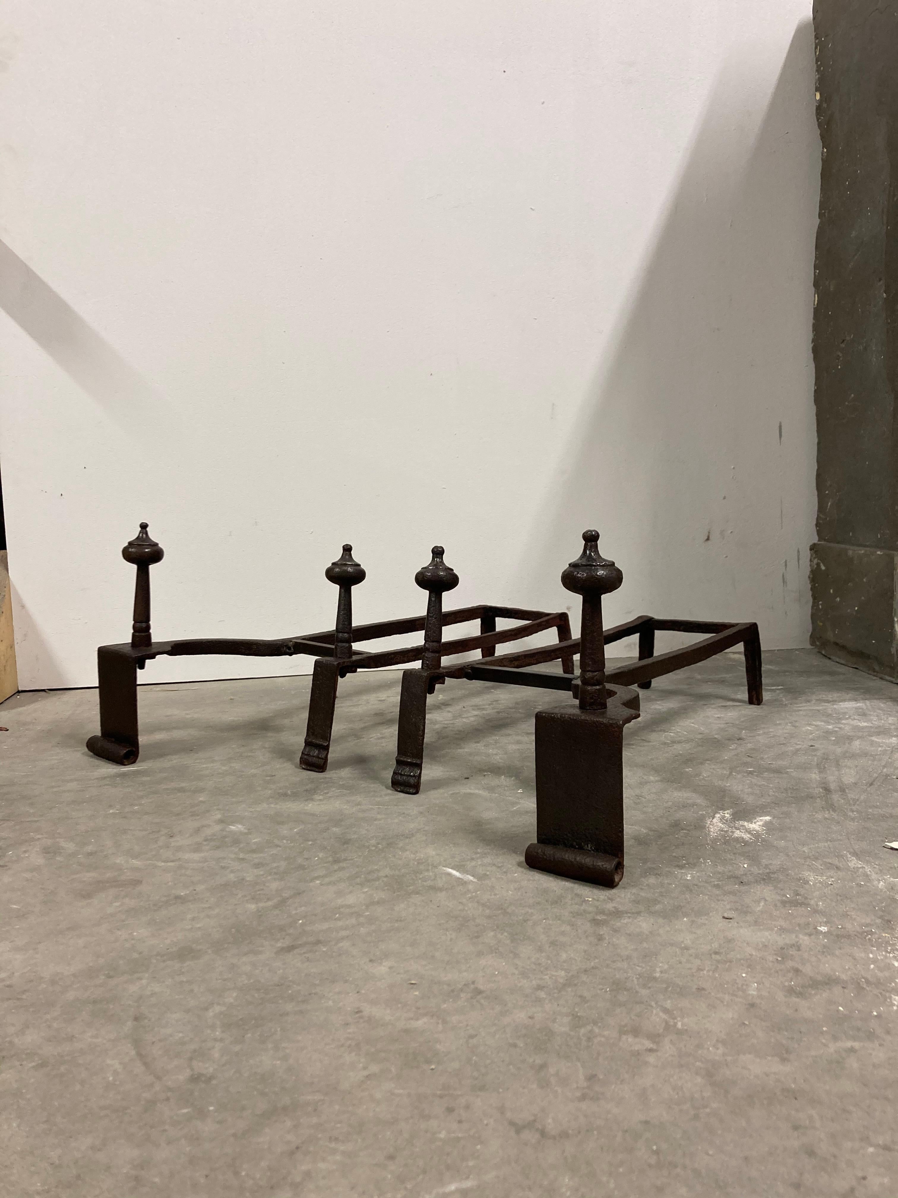Nice set of 18th century French andirons.
They are beautifully crafted by a talented blacksmith.
The front bar is of later date to add stability.

These andirons are easy in use and make stacking logs easier and safer. They also “fill” the