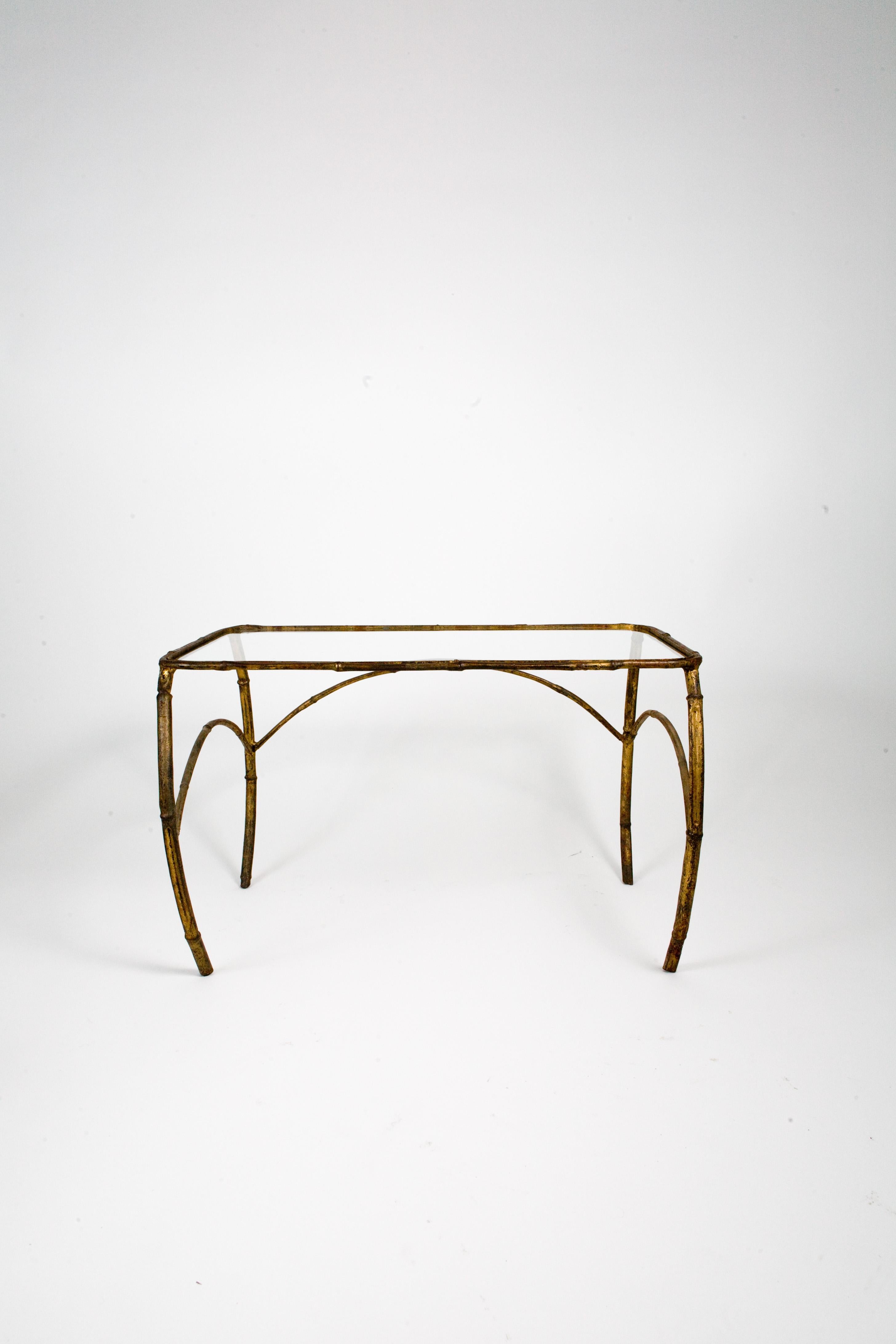 Set of three 1940s French Art Deco gilt metal nesting tables with curved faux bamboo metal legs and fitted glass tops.