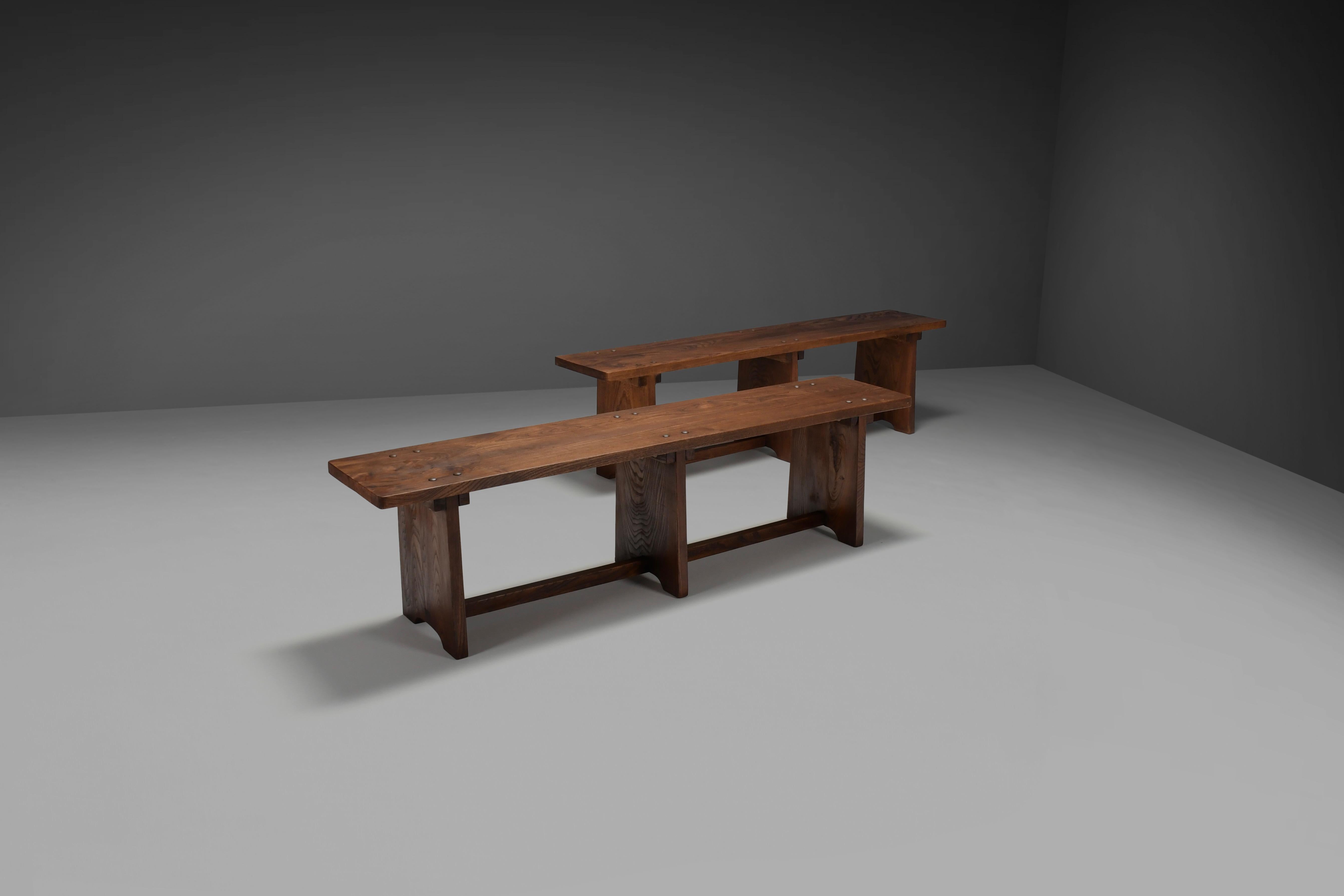 Set of impressive artisan benches in very good original condition.

These benches are made of a beautiful solid elm wood in a warm dark color.

They show a stunning patina and wood grain which adds to their character.
 
The seat is attached to the