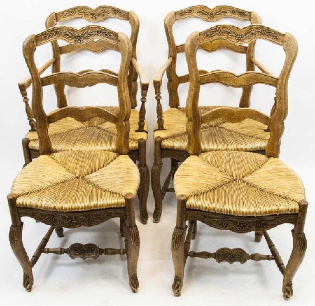 Set of French country Provençal carved ladder back dining chairs. Pine w/ waxed finish, rush woven seats, hand carved elements. 2 with arms are 38