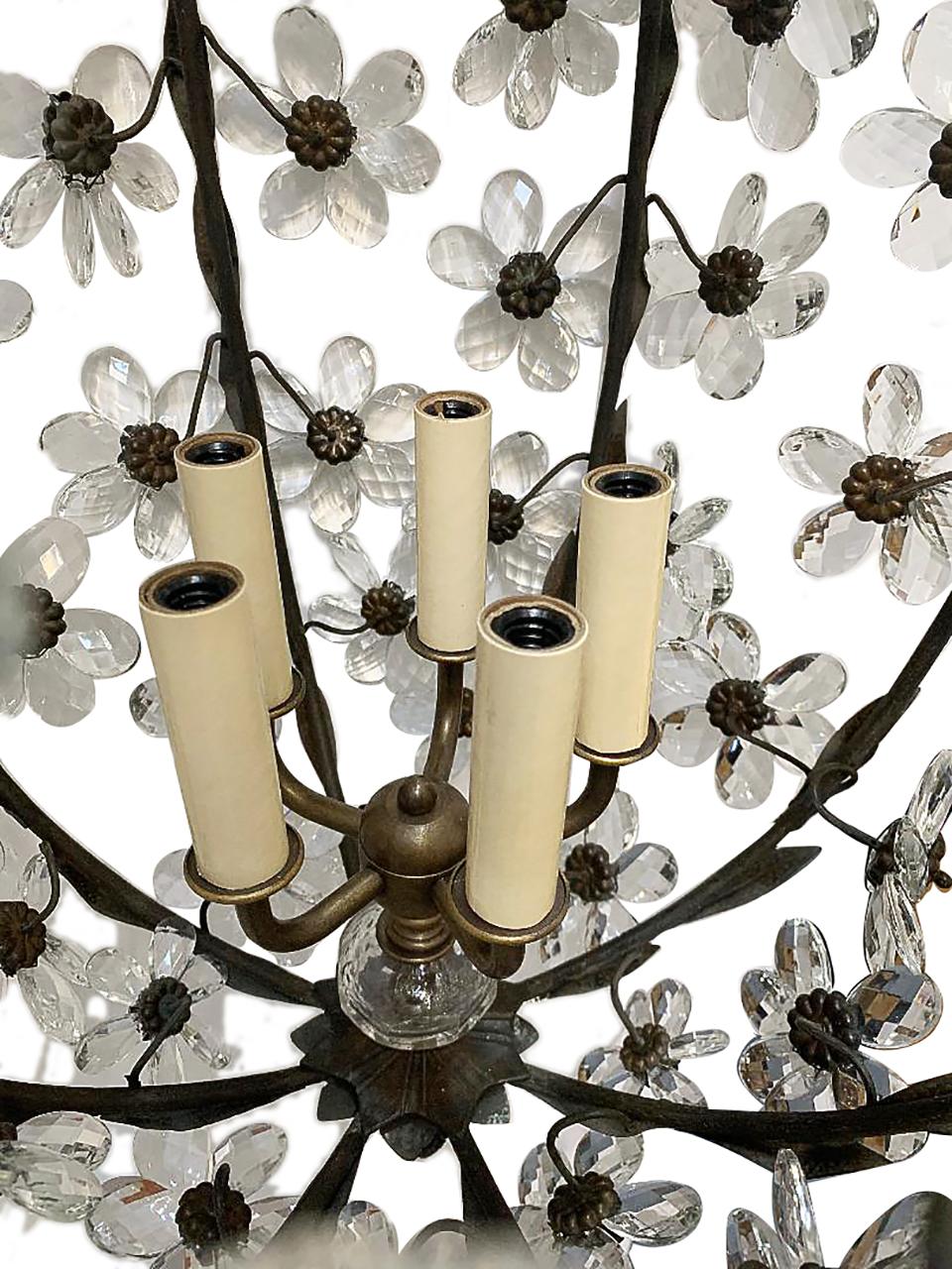 A set of three French circa 1930s patinated bronze and crystal flowers chandeliers with a 5-light interior cluster. Sold individually.

Measurements:
Minimum drop 31