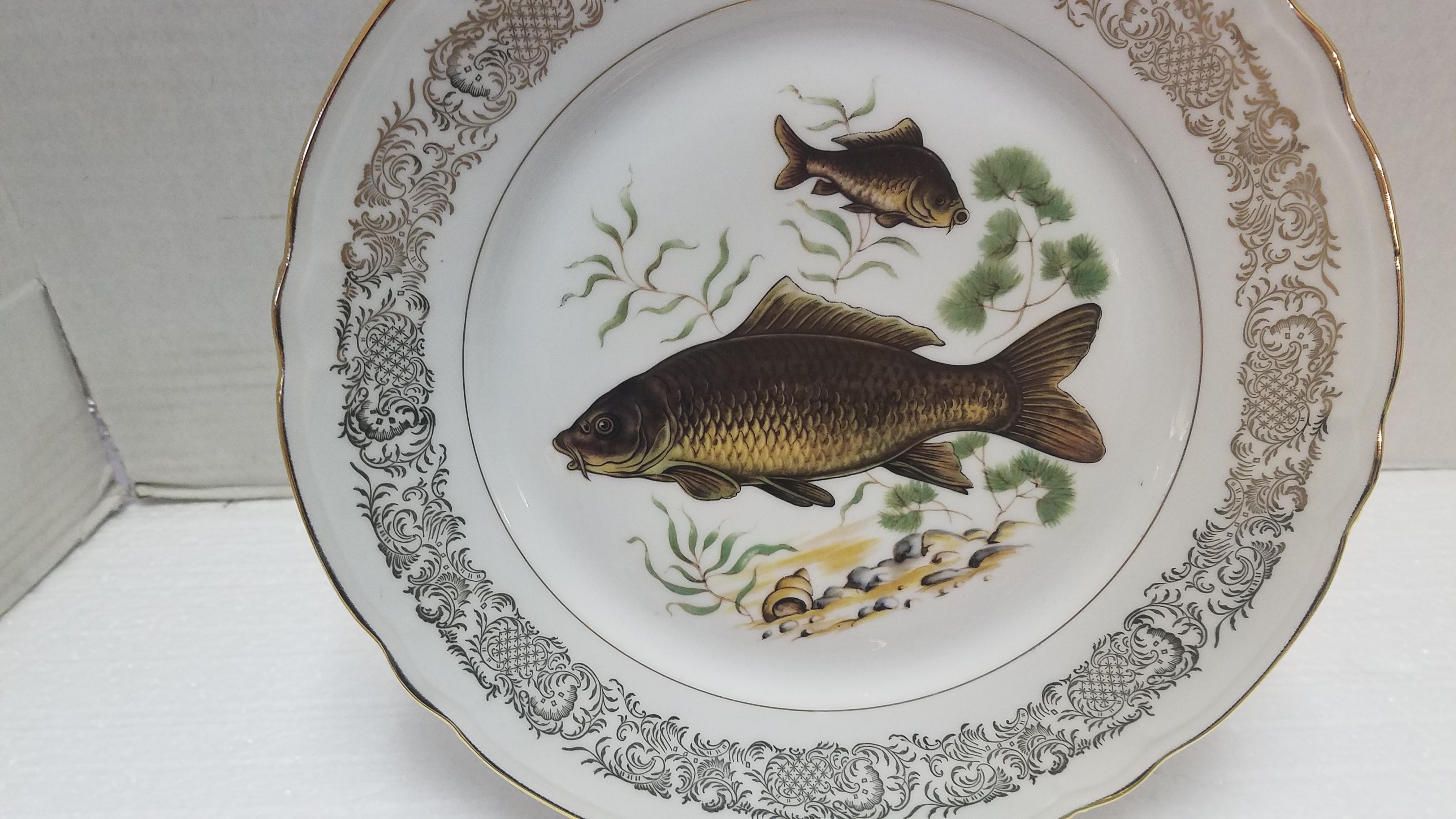 Set of 12 dinner plates and 1 gravy bowl. Vintage French Porcelain hand painted with 6 different fish (2 plates of each fish species). All beautifully accented with 24-carat gold. Please see all photos for details. Makers mark on the back 