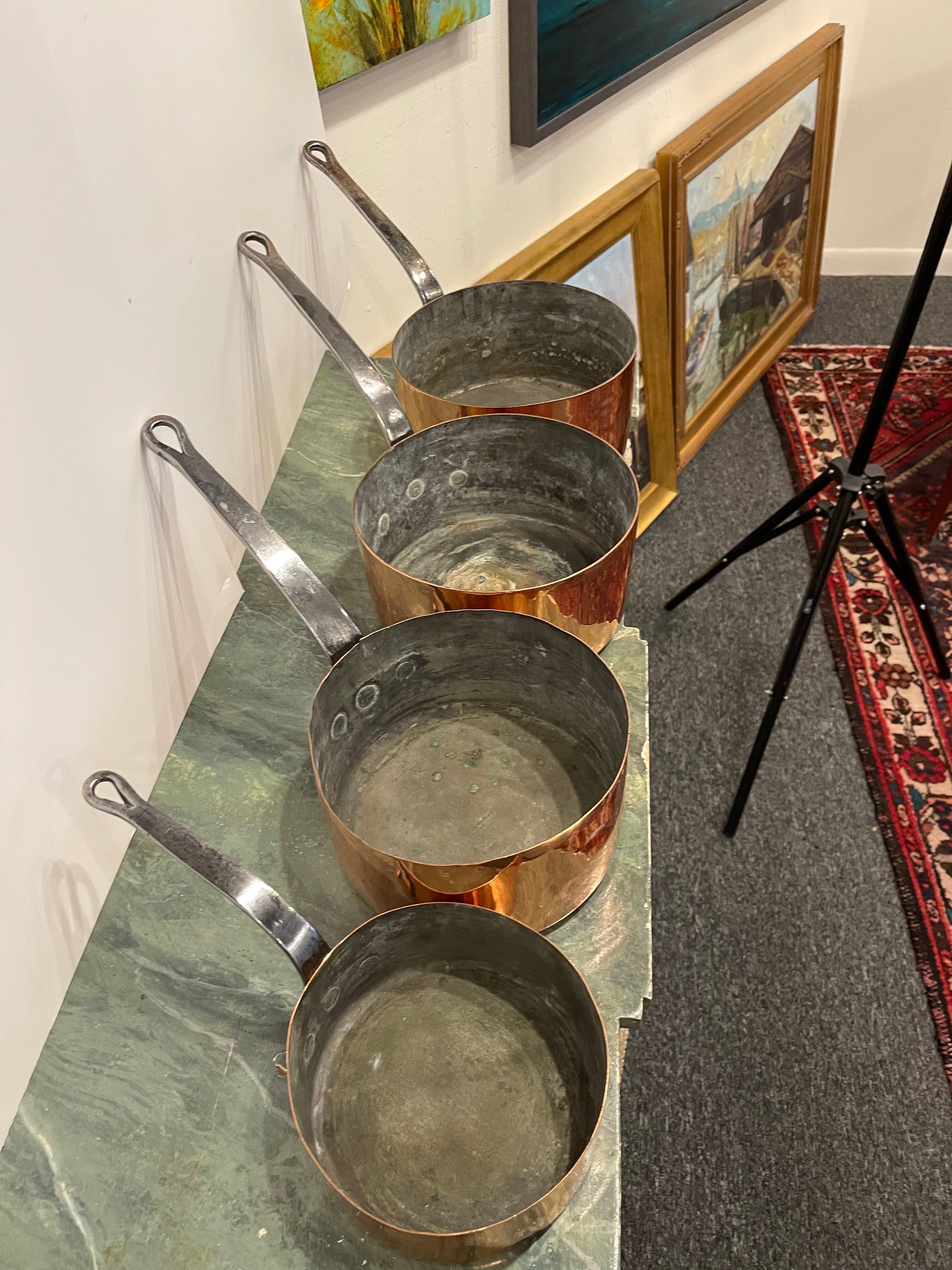 Set of French Four Copper Pots in Different Sizes, 19th Century.  Professionally cleaned and polished in France.  A light coat of copper was applied.

Diameter Dimensions
7
