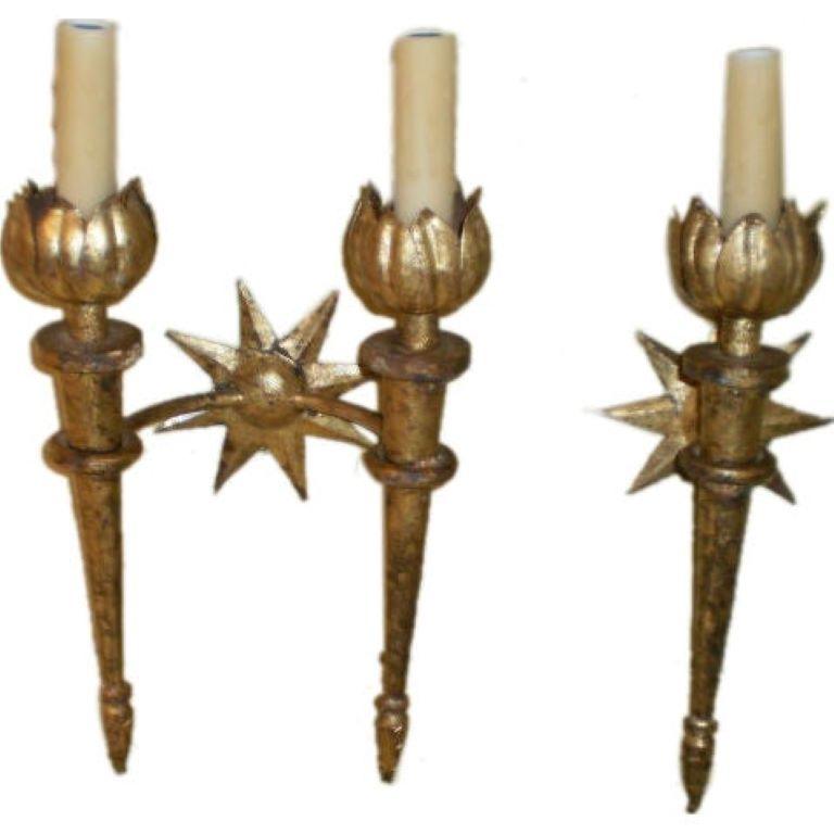Set of French gilt iron sconces after Gilbert Poillerat.
Stunning pair of French gilt iron sconces in the manner of Gilbert Poillerat. These fantastic torch form sconces have a beautiful star backplate and great patina. This set consists of a